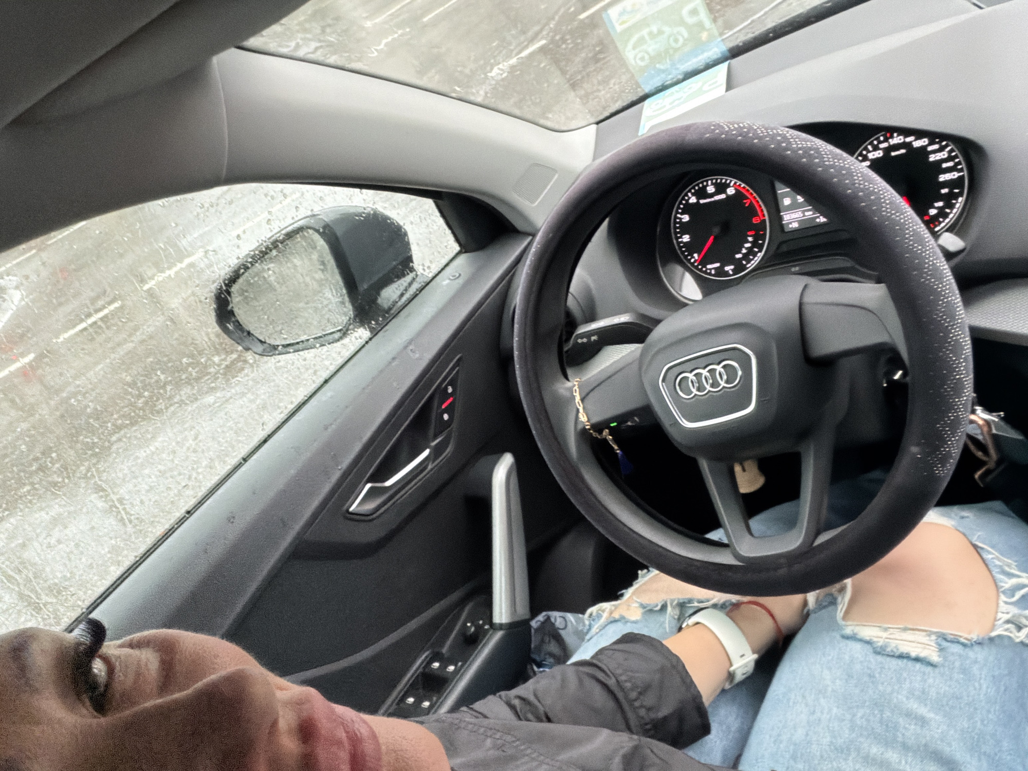 Driver documents rainy journey through European city with Alpine architecture