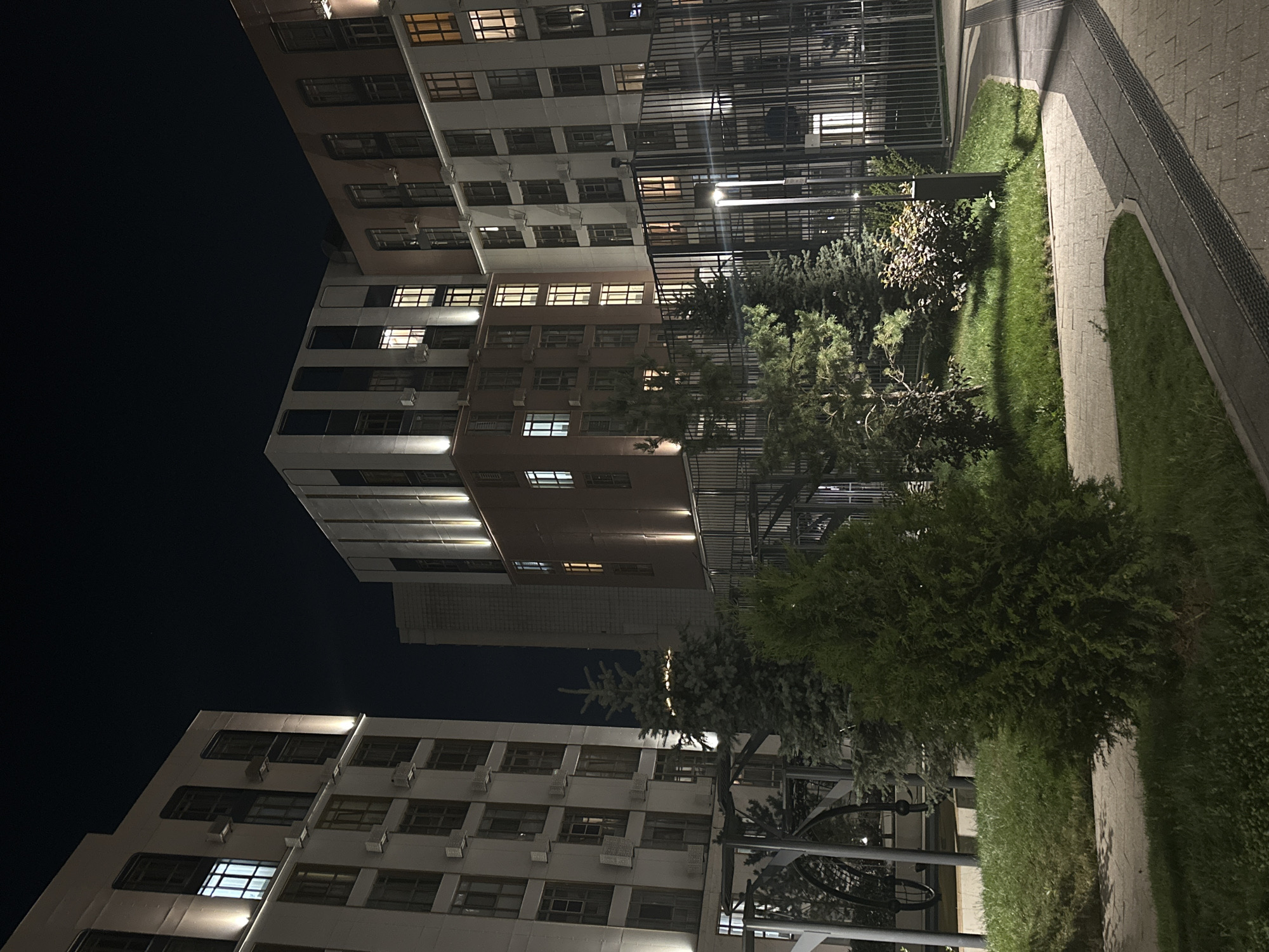 Nighttime walkthrough of a modern apartment complex and its gardens