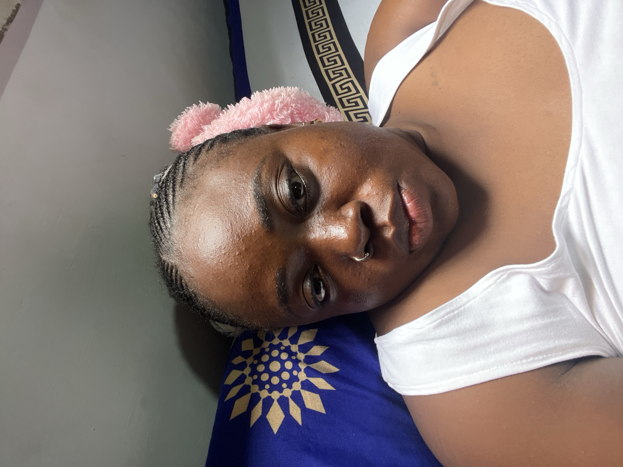 Lazy afternoon bedroom moments in Abuja with phone and plushie