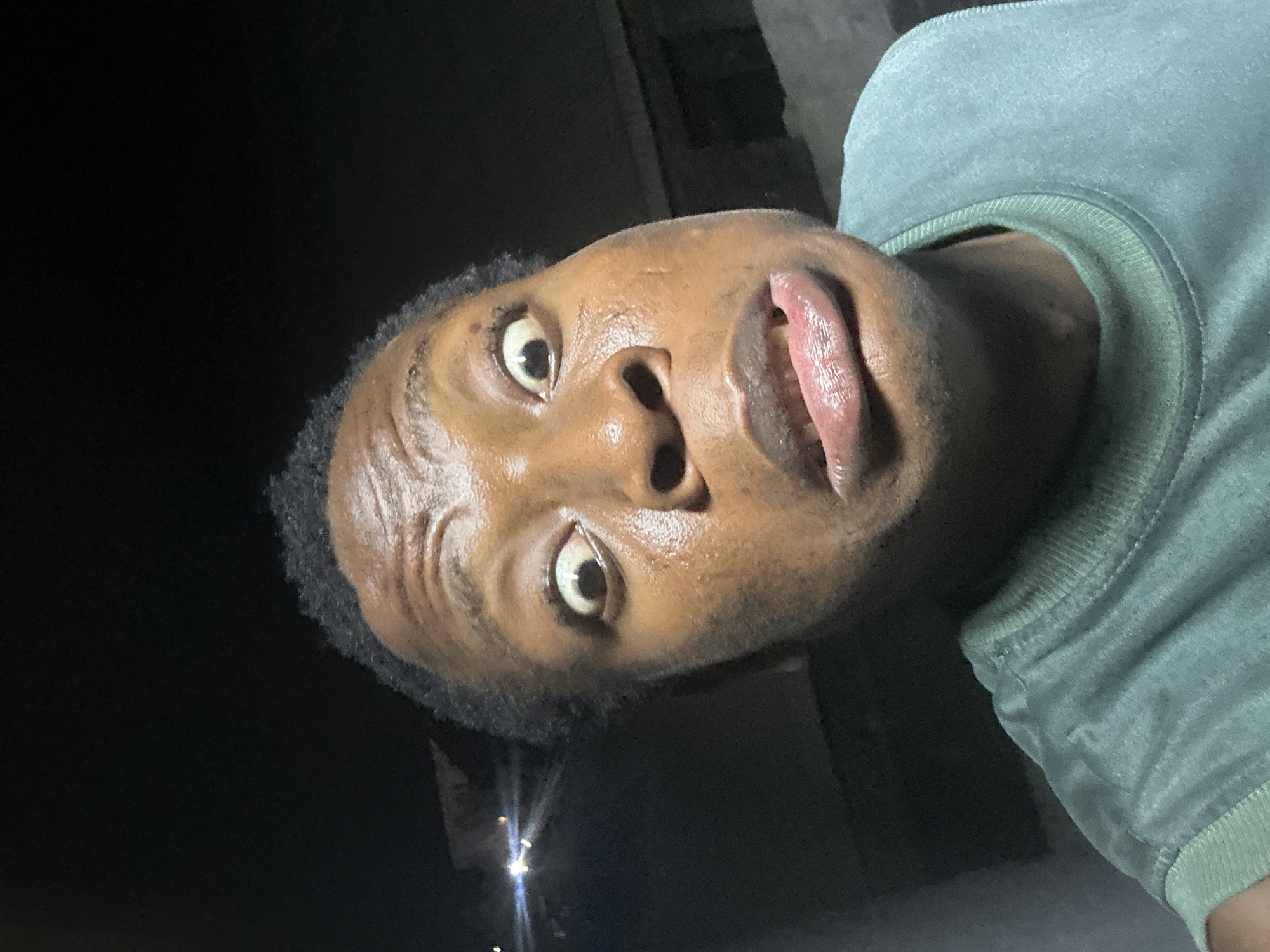 Person Takes Multiple Selfies Under Streetlight, Shows Perspiration