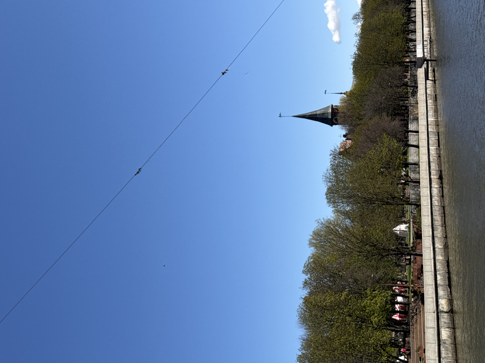 Tourist documents sunny morning walk through historic Kaliningrad waterfront