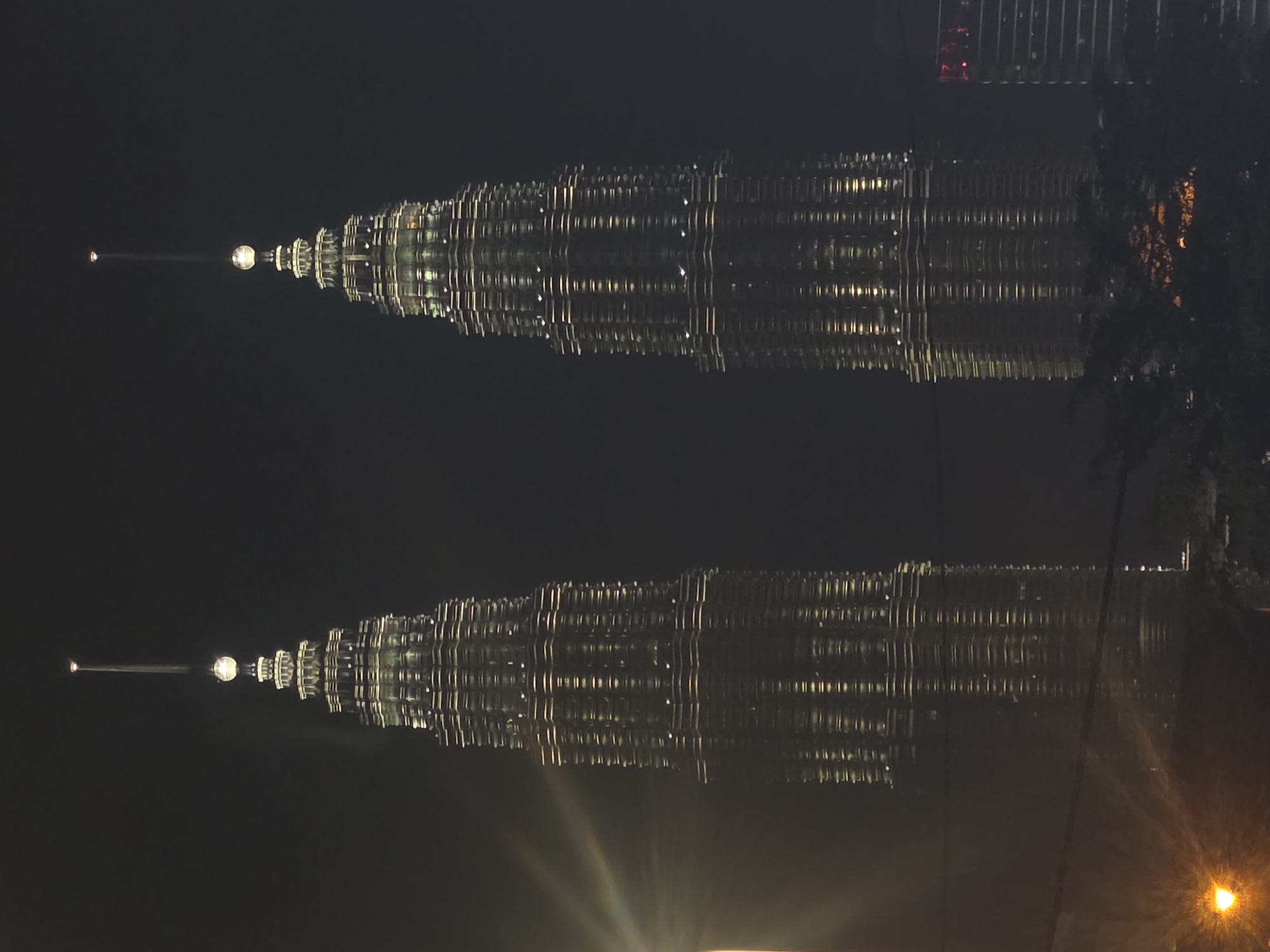 Petronas Twin Towers nighttime reflection captured in Kuala Lumpur