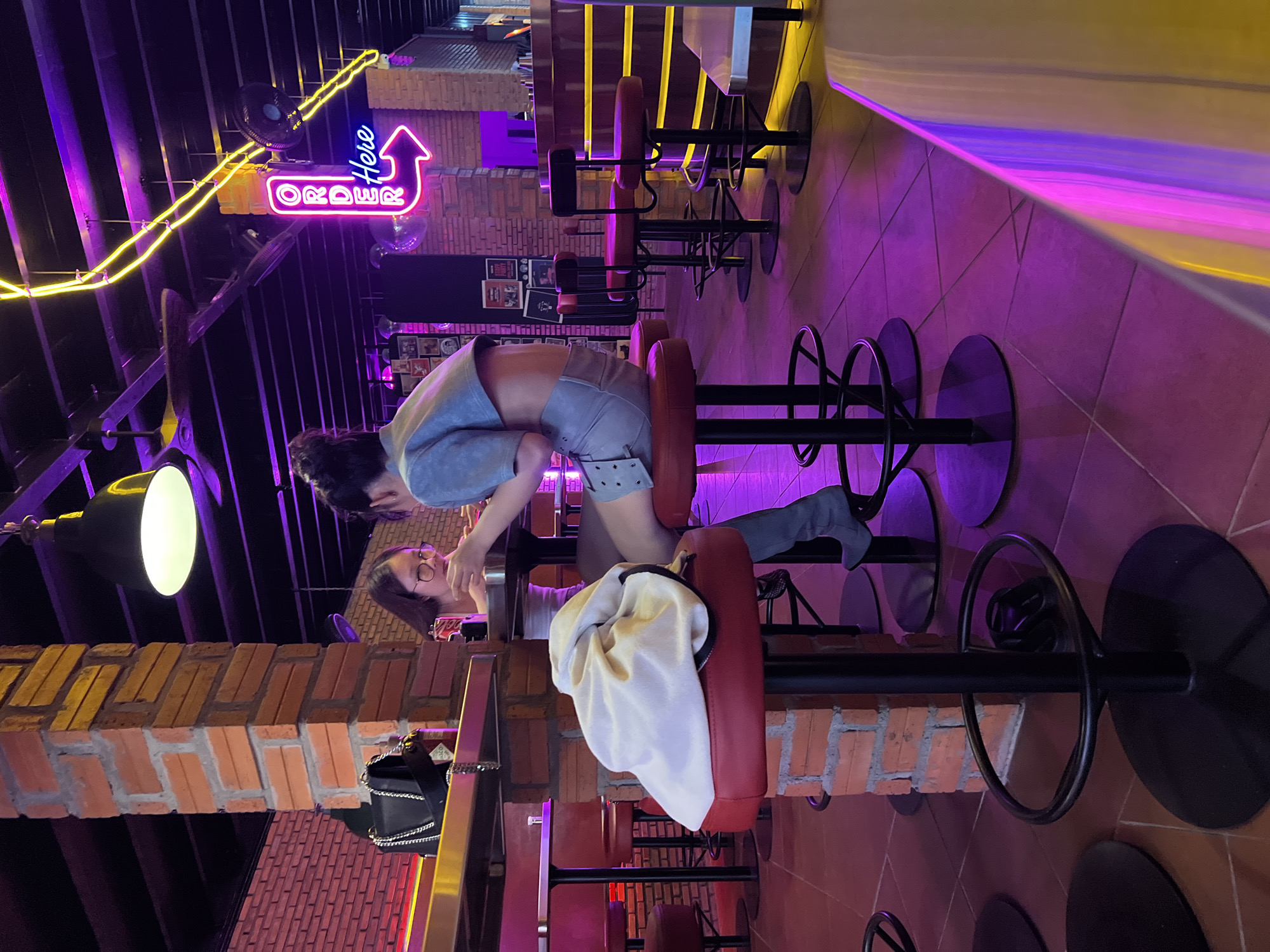 Casual dining and arcade gaming captured at Vietnam burger restaurant