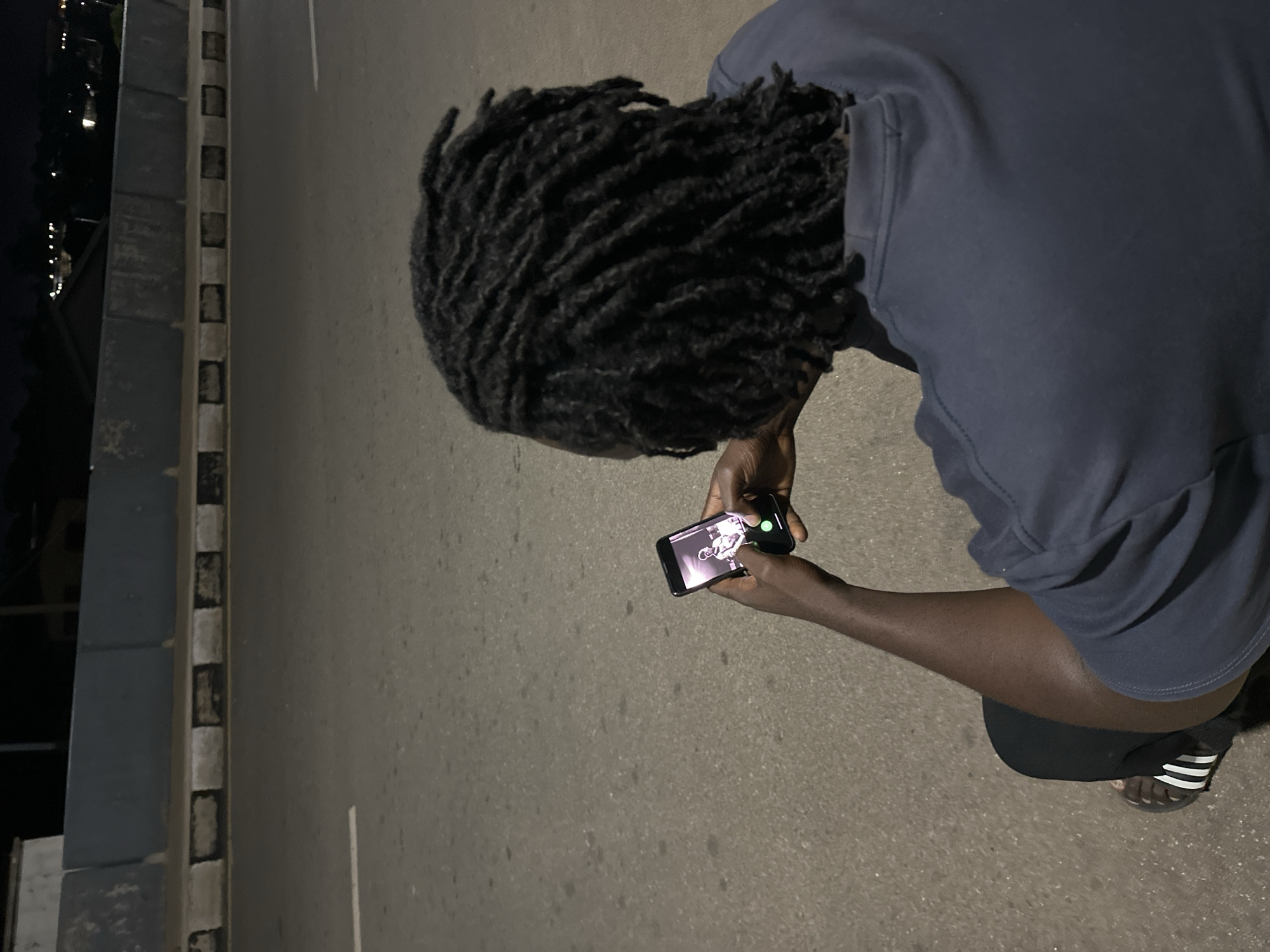 Hanging out on a lit street in Jos at night