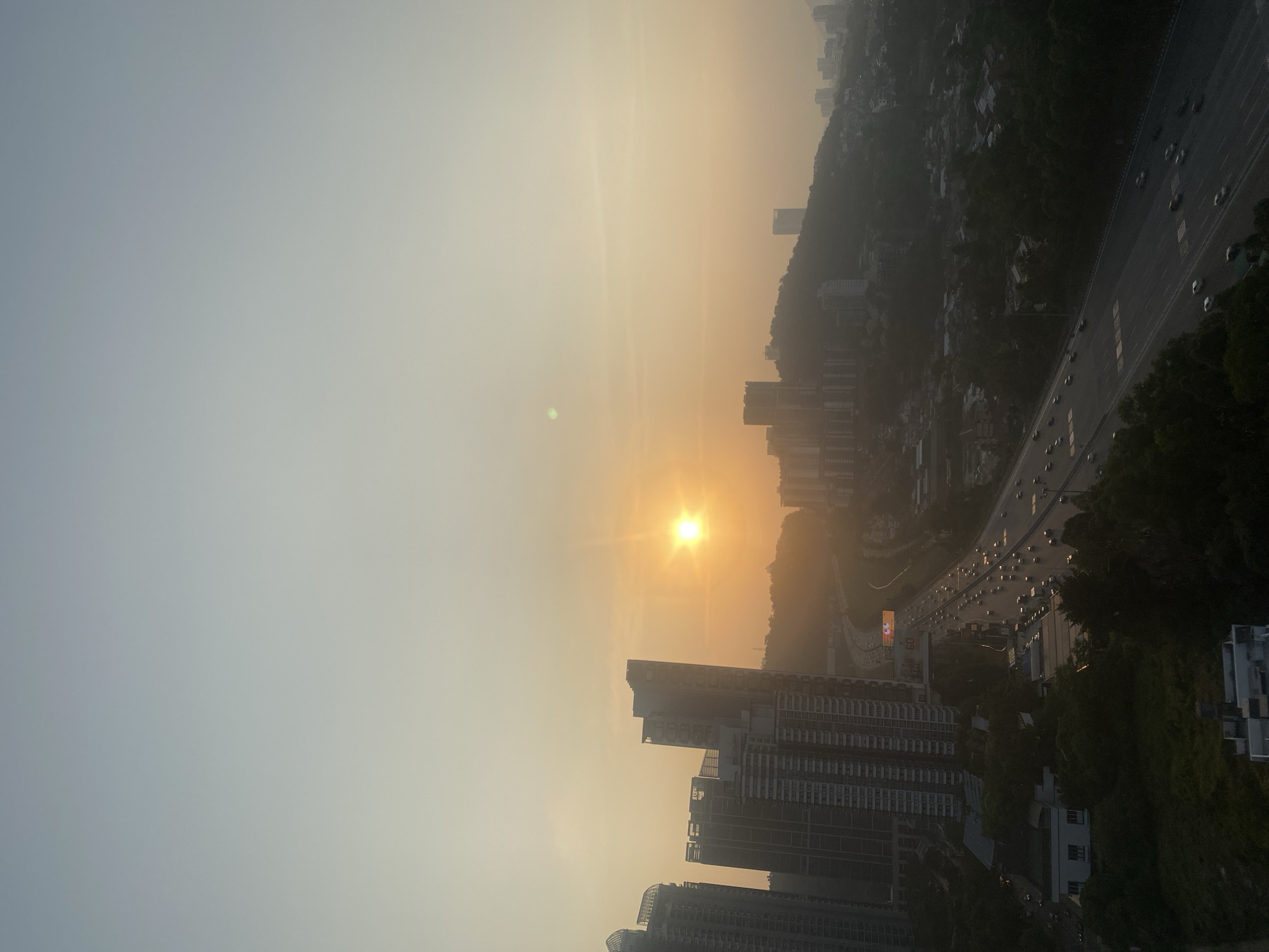 KL skyline transitions from hazy sunset to moonlit night