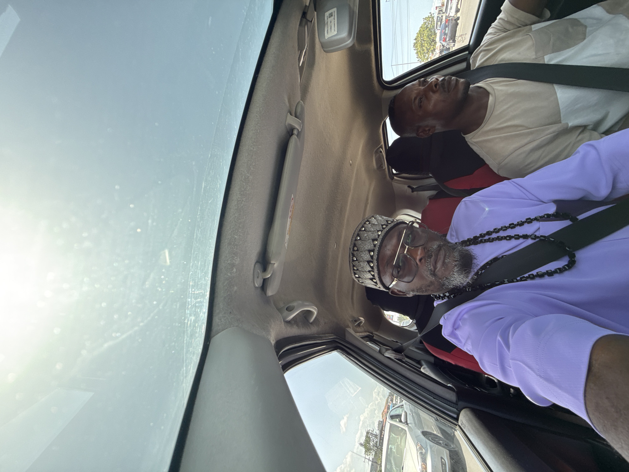 Two men travel by car in Ojomu, Nigeria