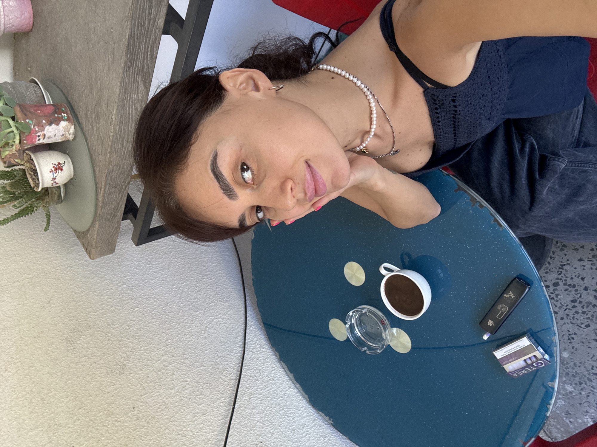 Café afternoon in Tbilisi, blue table, coffee, and selfies.