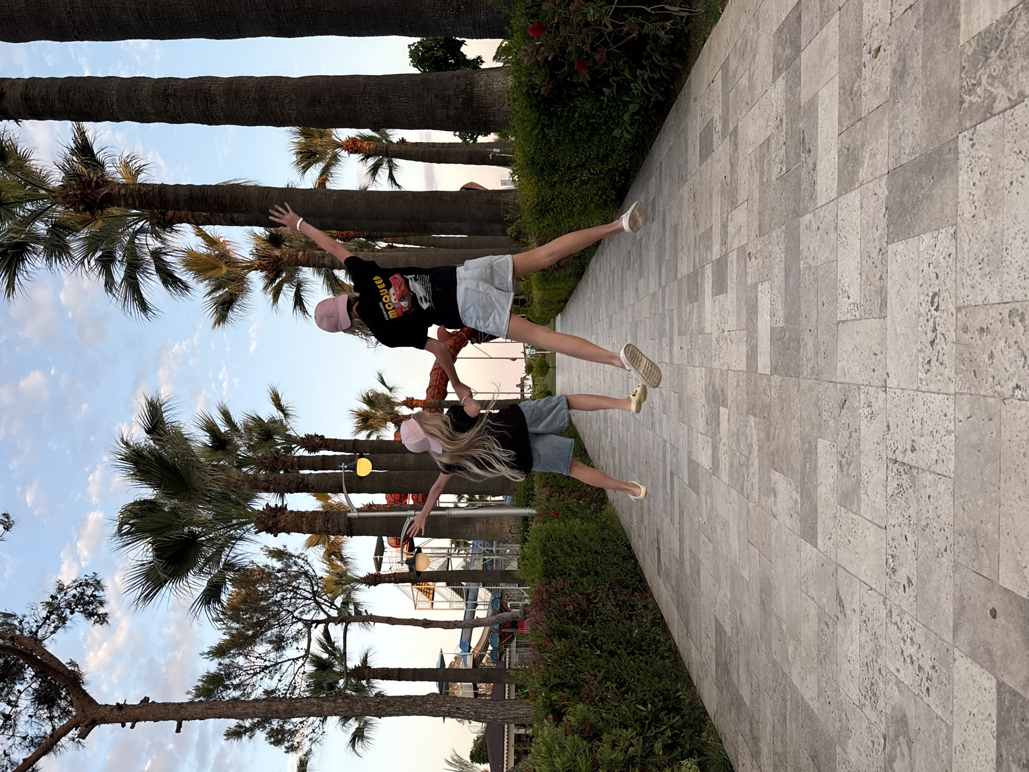 Two youths pose in matching outfits near Serik water park