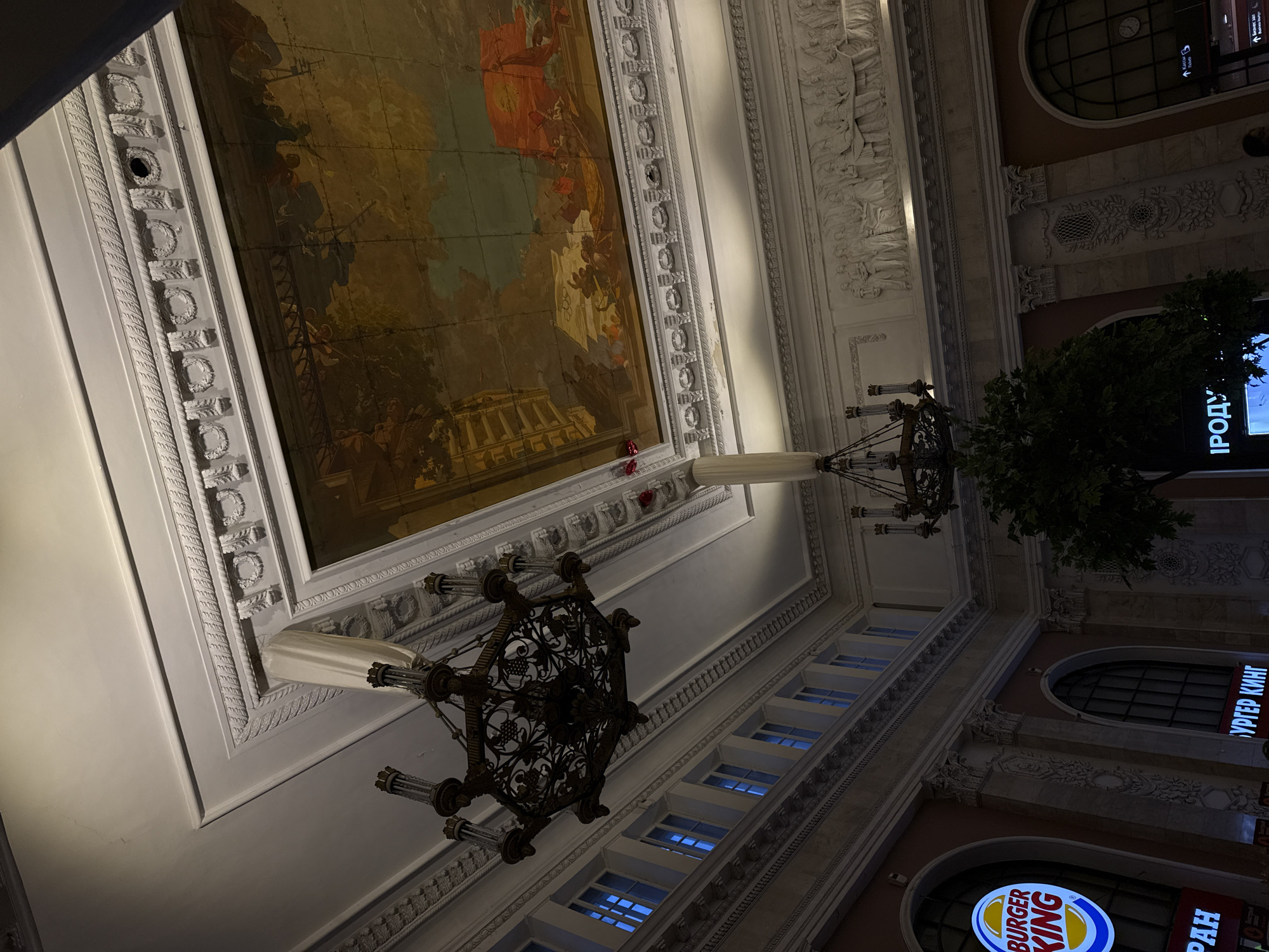 Visitor photographed in ornate Saint Petersburg building interior