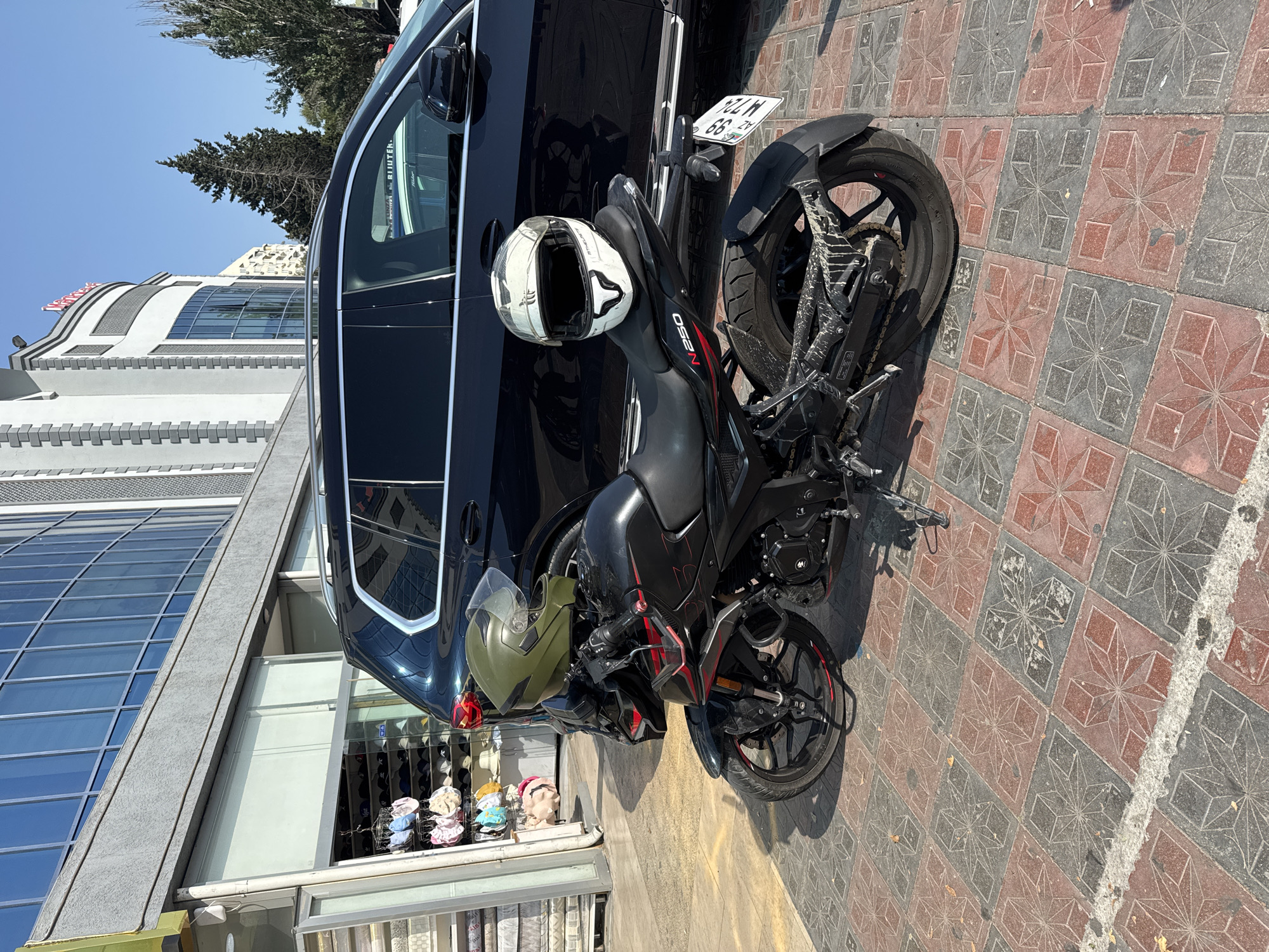 Street-level Baku: bikes, a vendor stall, and city signage