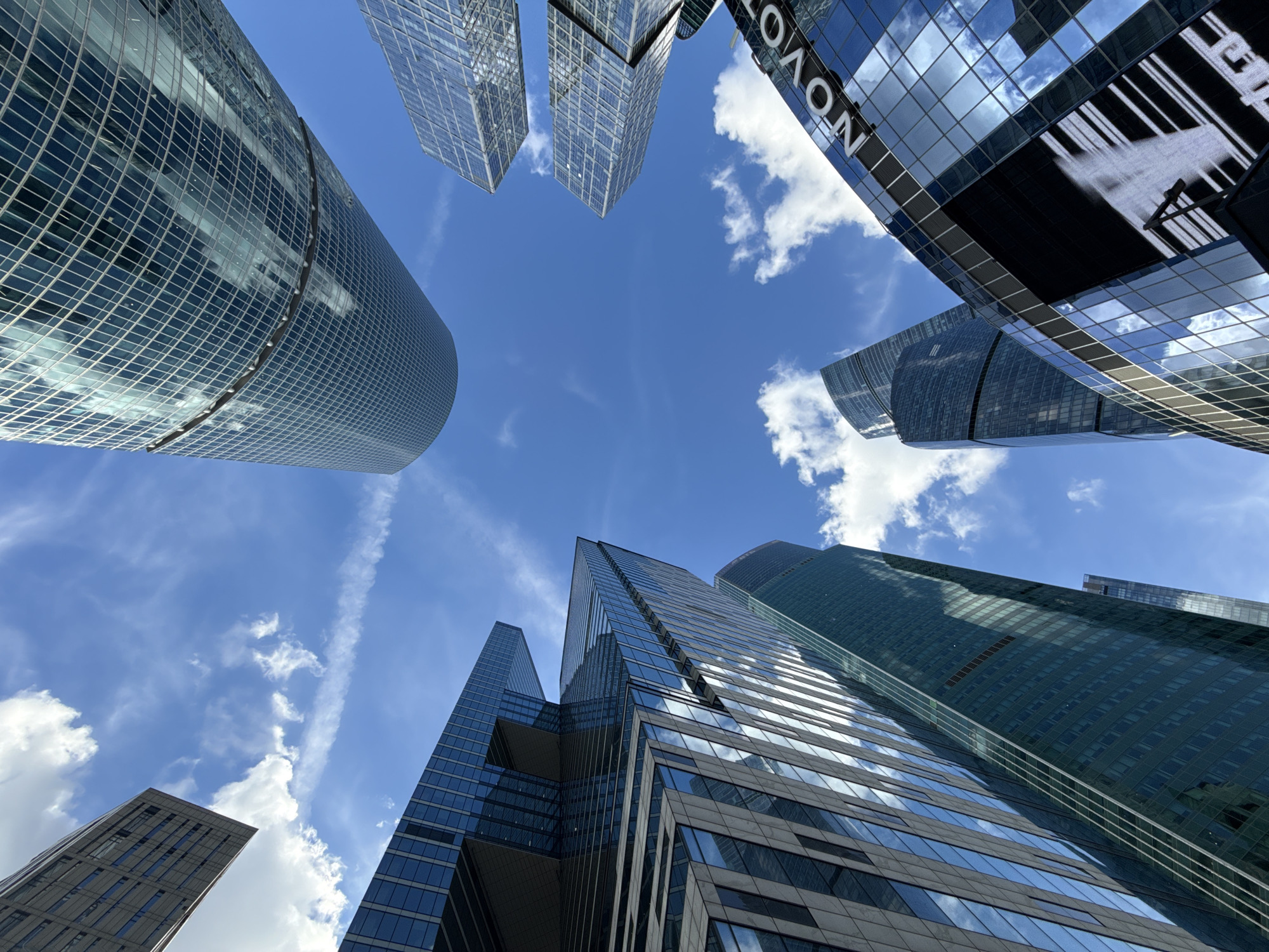 Looking up at Moscow City's towers on a clear summer day