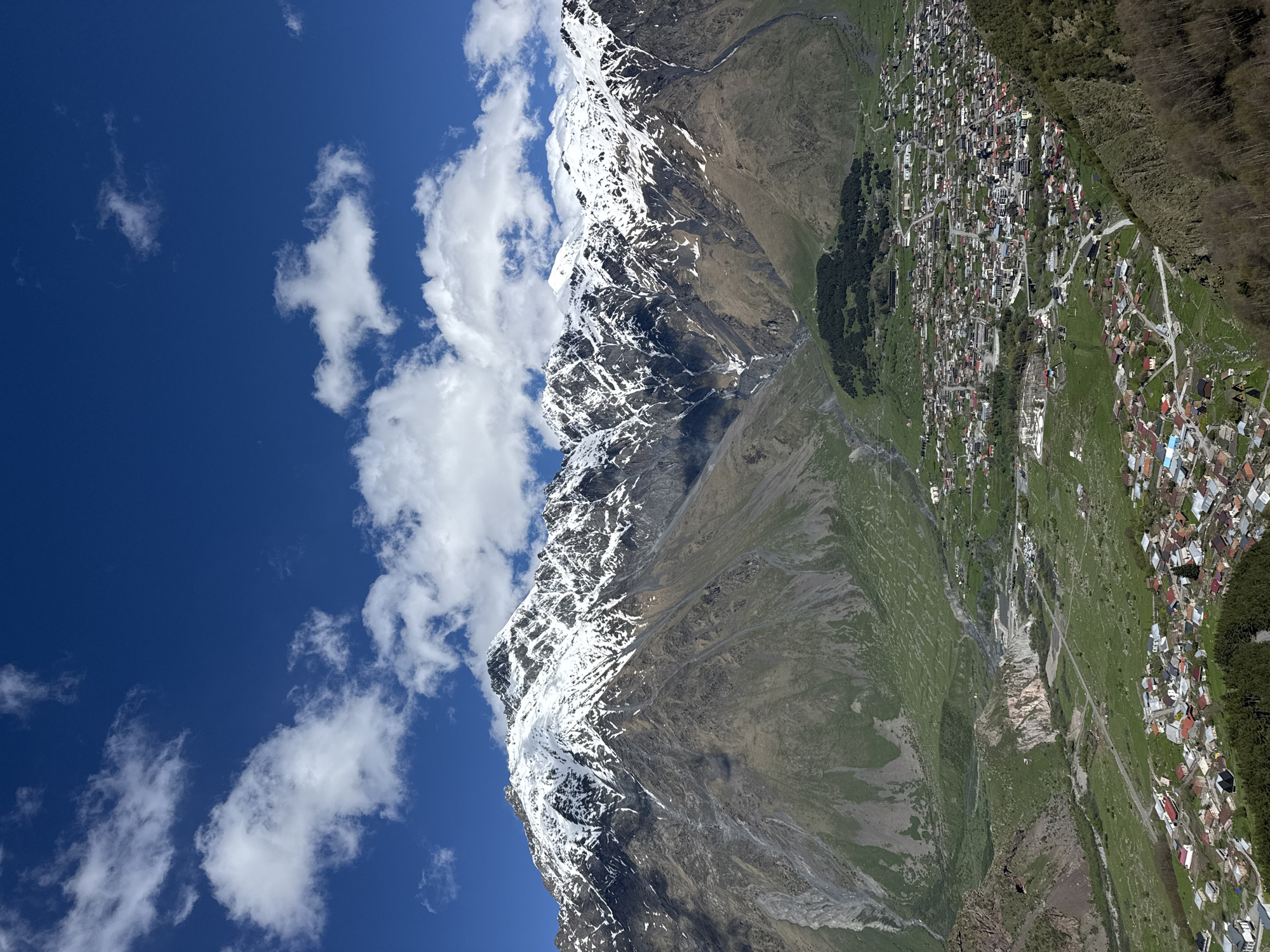 Tourist visits historic Gergeti Trinity Church in Georgian mountains