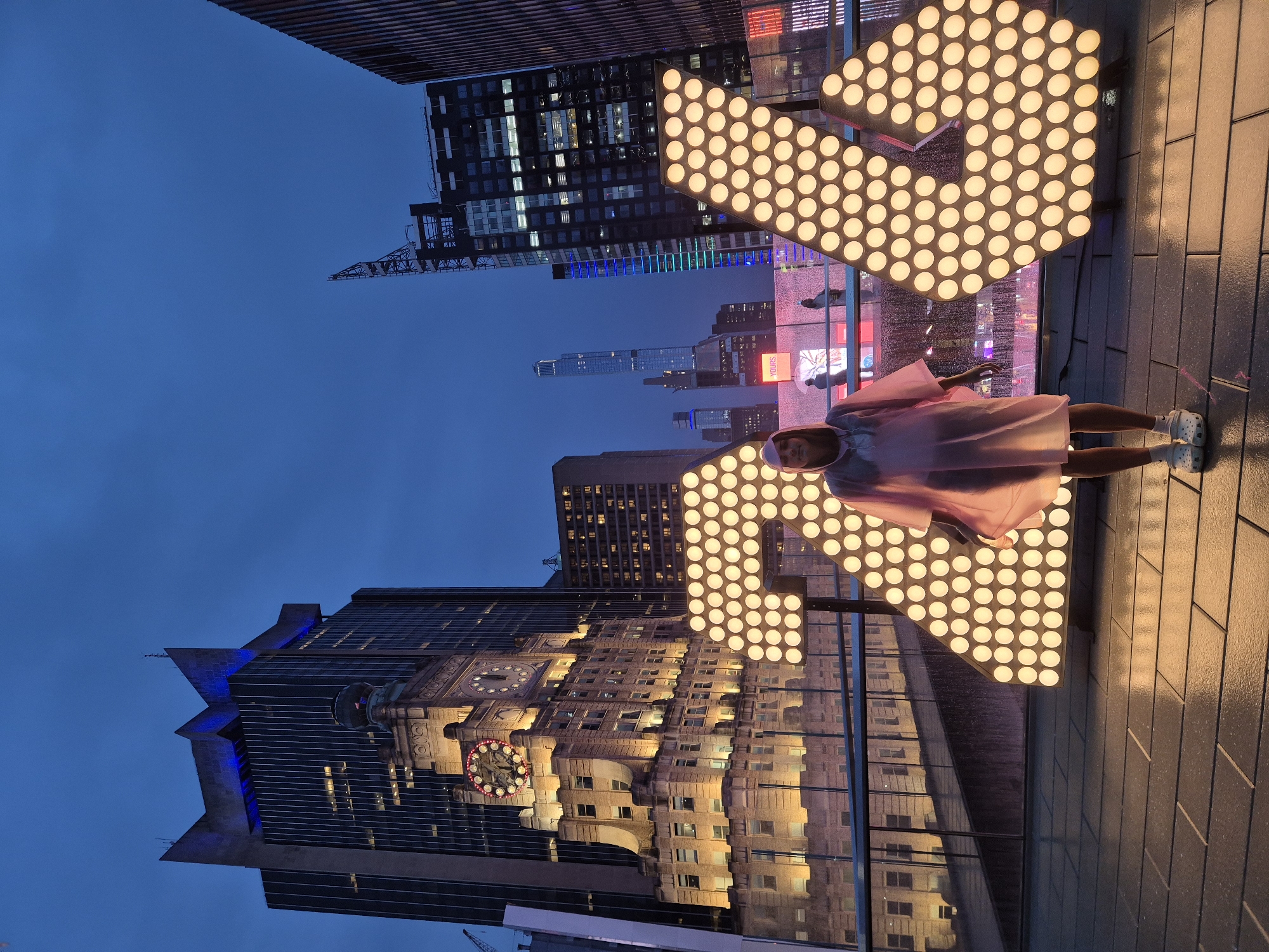 Times Square at night: glowing '24' installation and busy streets