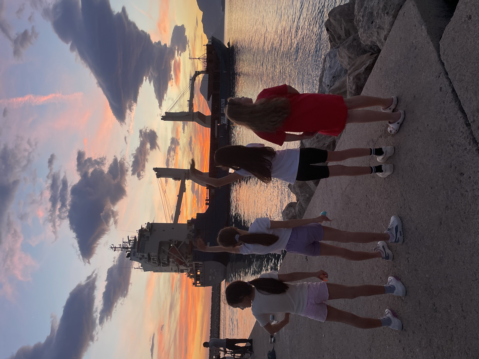 Sunset watchers gather at Bar Montenegro harbor pier