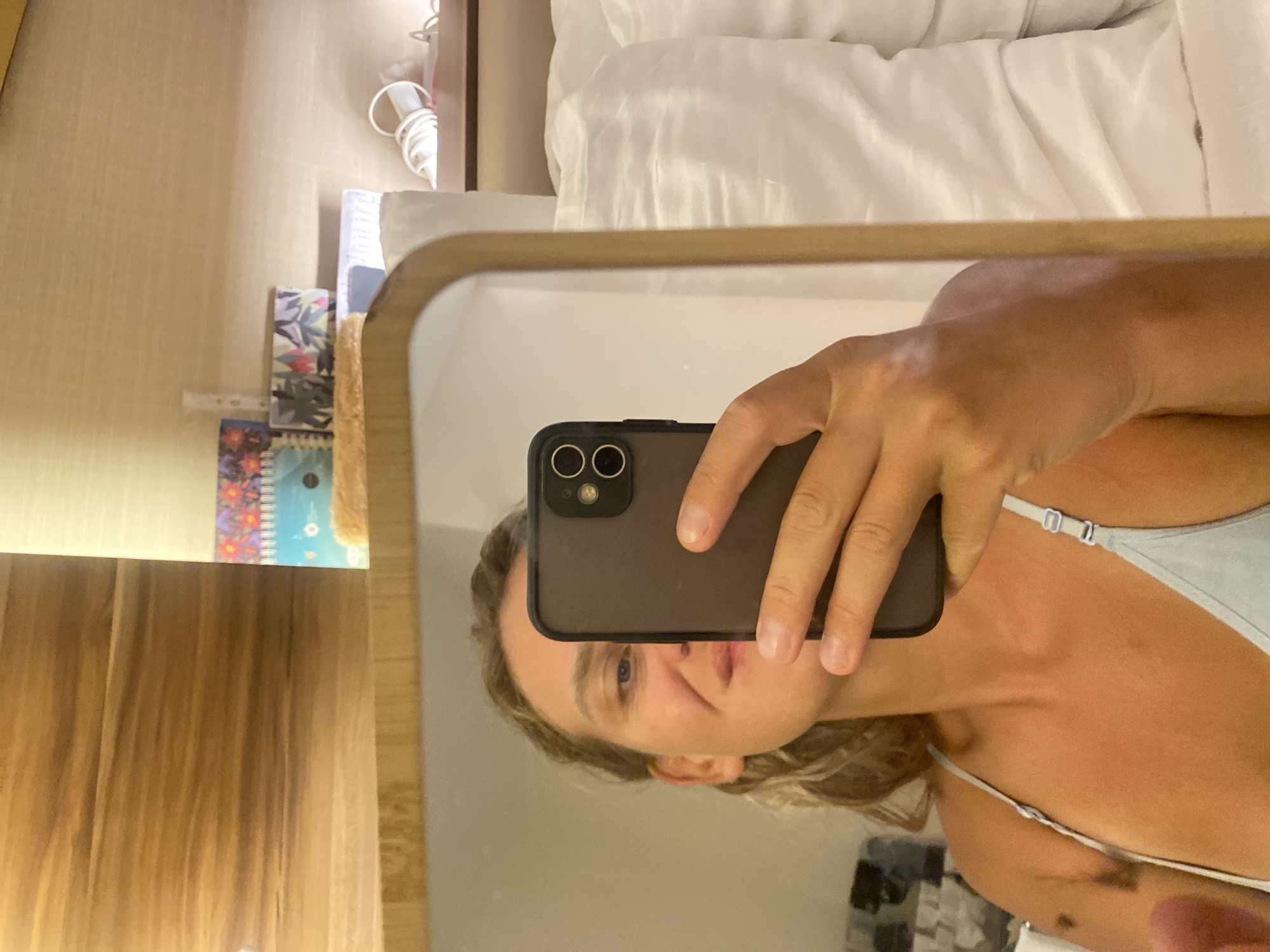 Mirror selfies and bedside details from a hotel room in Aksu