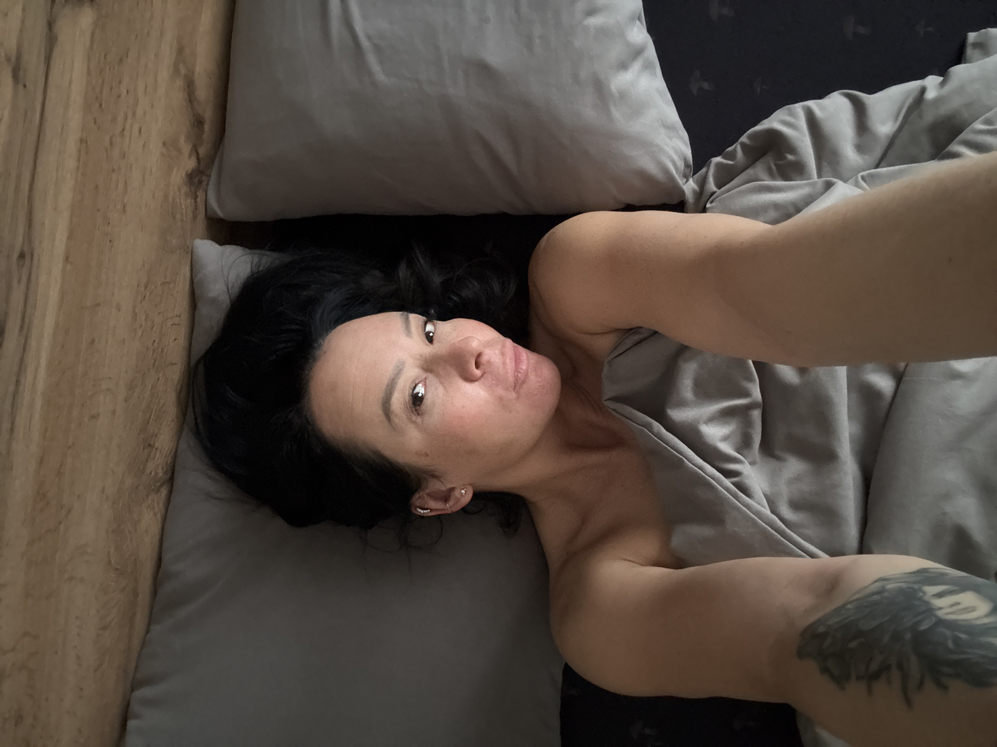 Woman and dog captured in quiet bedroom moments in Chaikovsky