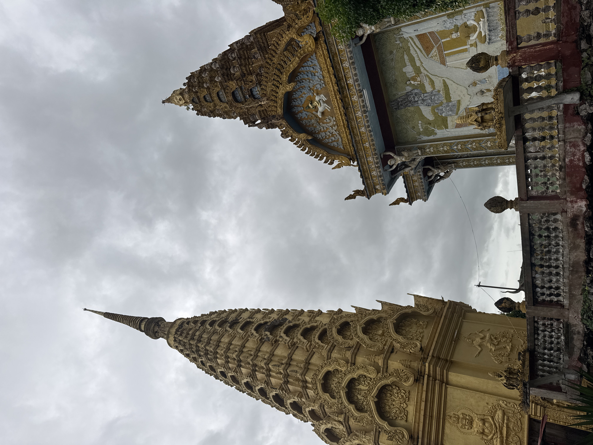 Golden stupas and Khmer temple rooftops in Sneung, Cambodia