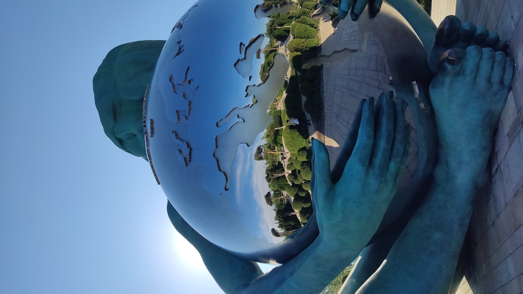 Teal globe sculpture monument in Krasnodar park setting