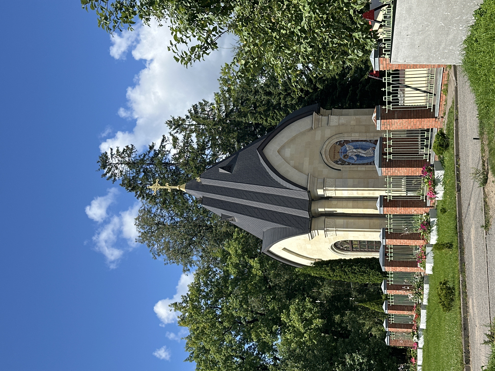 Summer morning at a Vsevolozhsk park, playground, and chapel