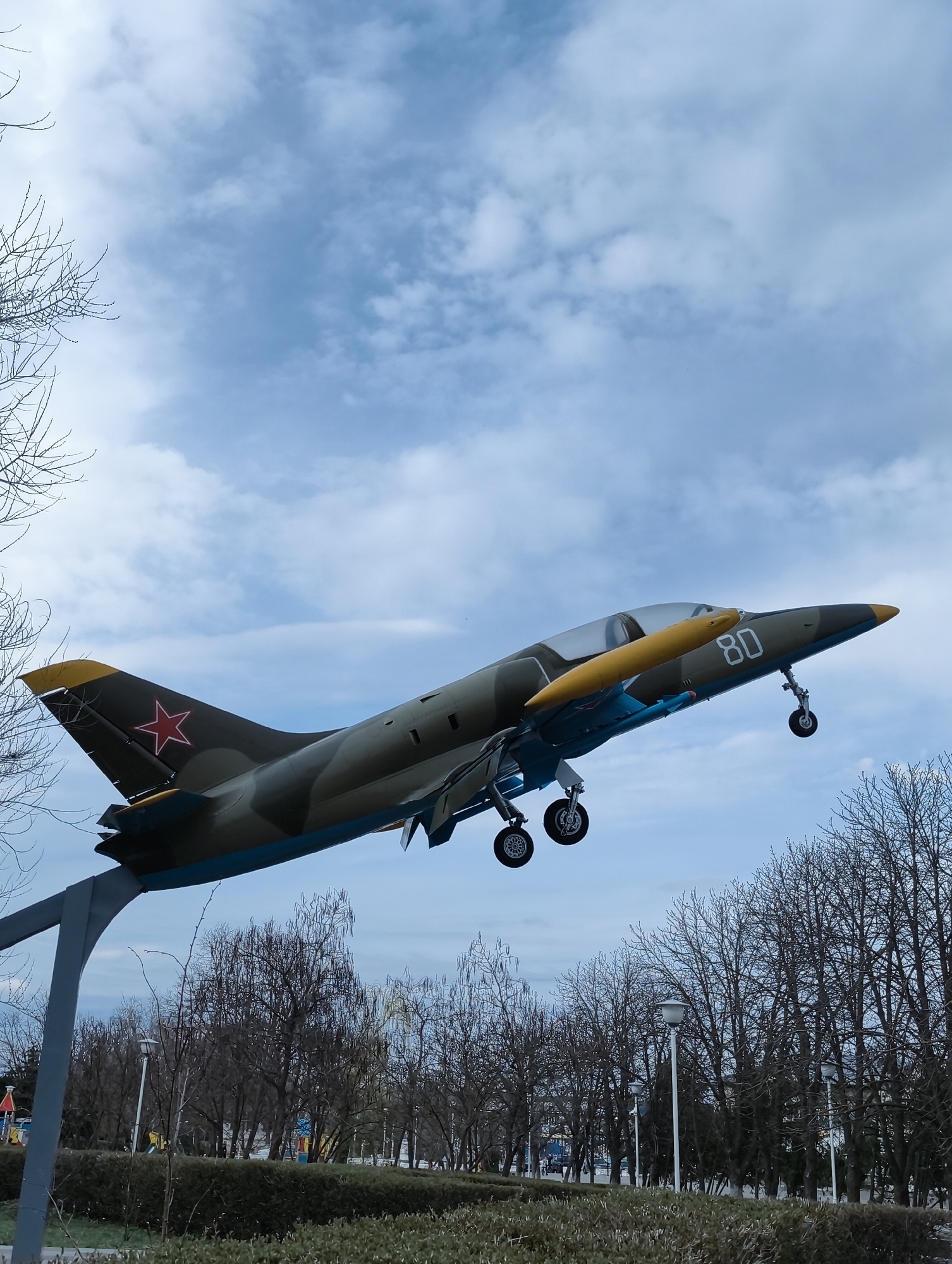 Military aircraft monument and educational owl statue observed in Balashov