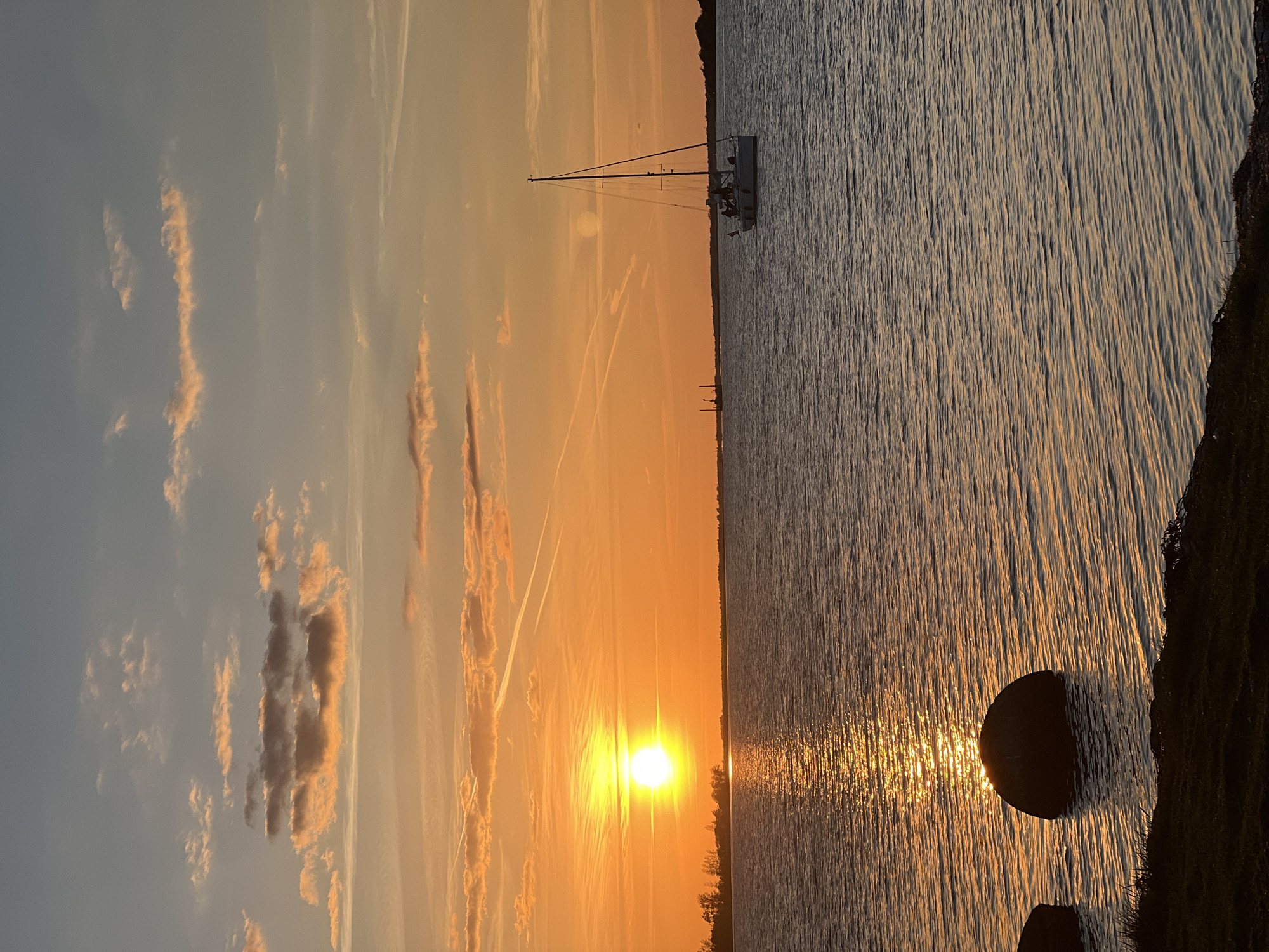 Sunset documented over Aalborg waterfront with sailboats Thursday evening