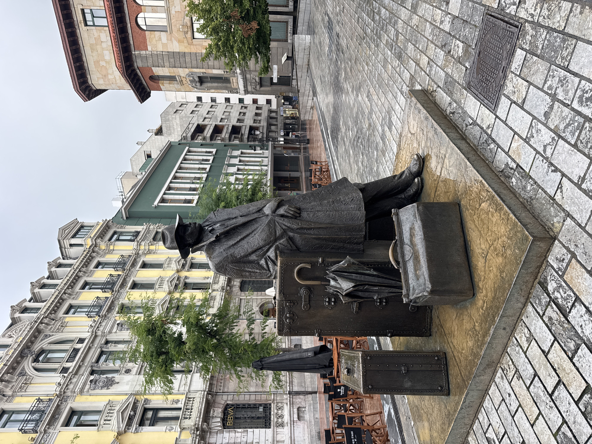 Exploring Oviedo's famous bronze statue trail on a rainy evening