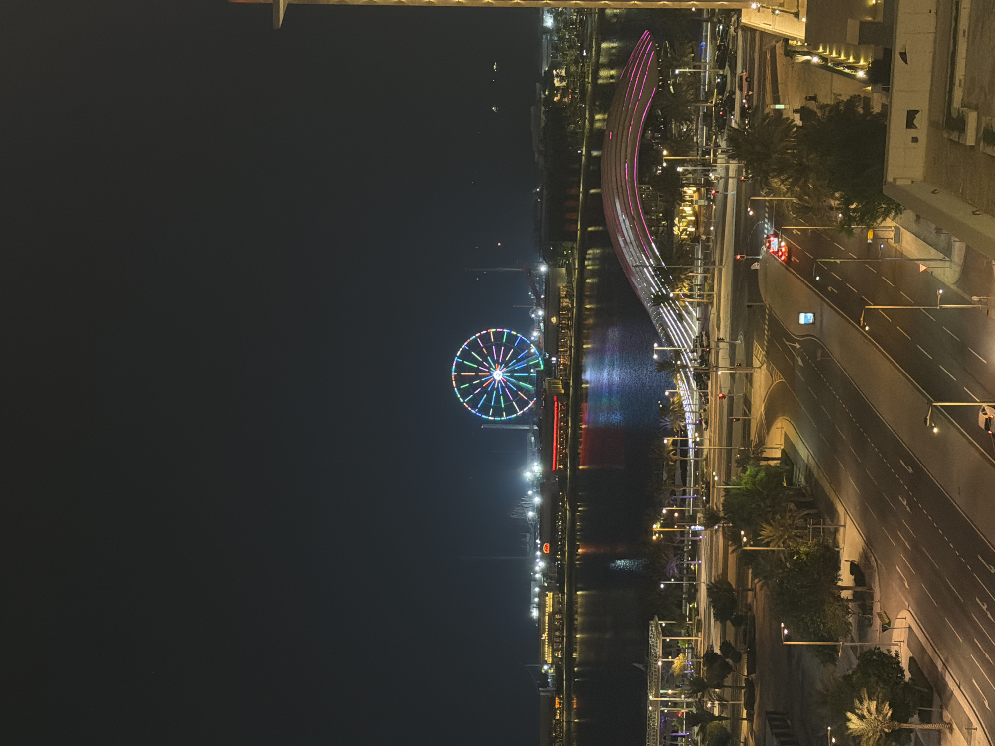 Lusail at night: waterfront Ferris wheel and glowing skyline