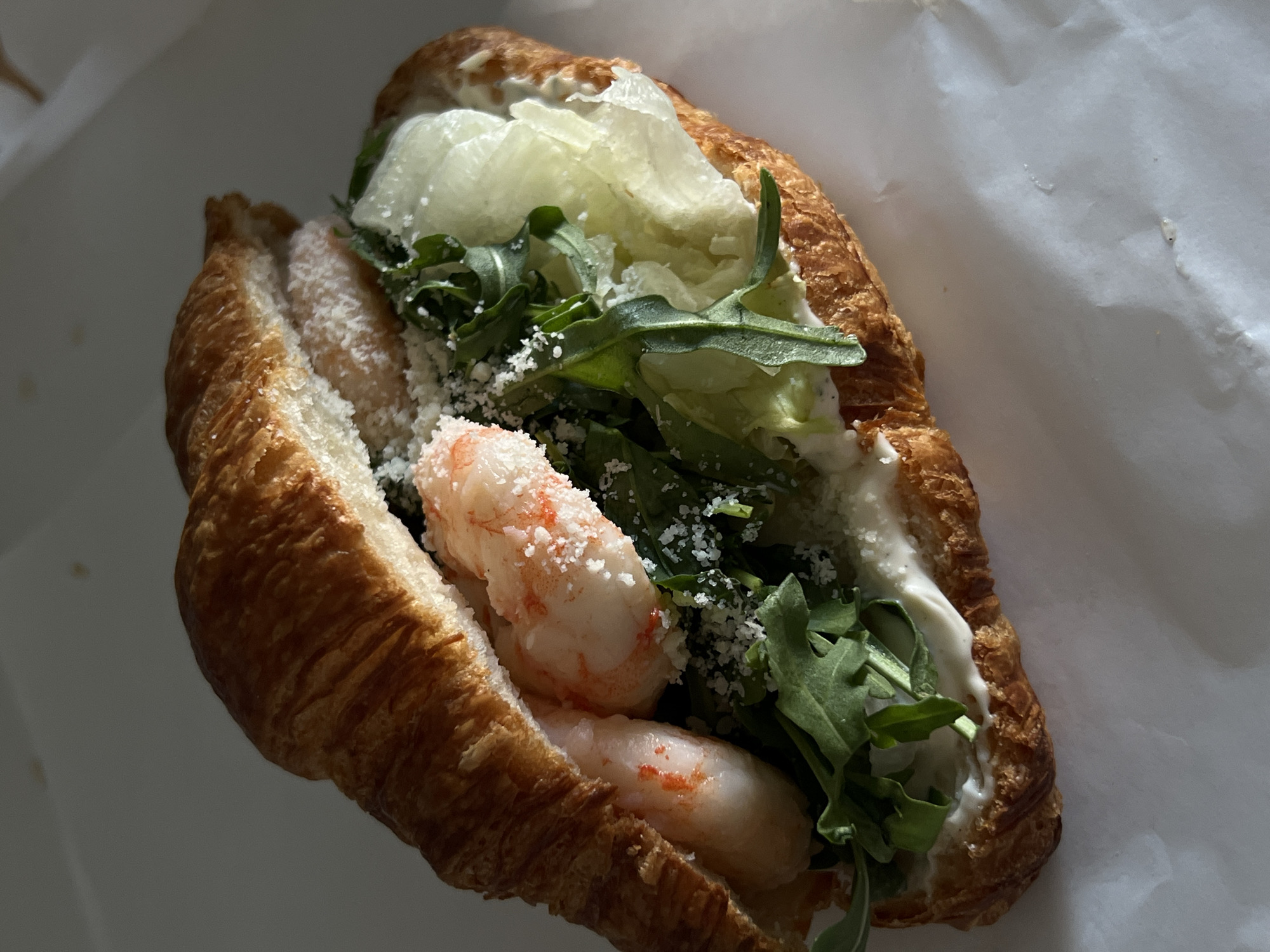 Shrimp and arugula croissant sandwich in Lviv