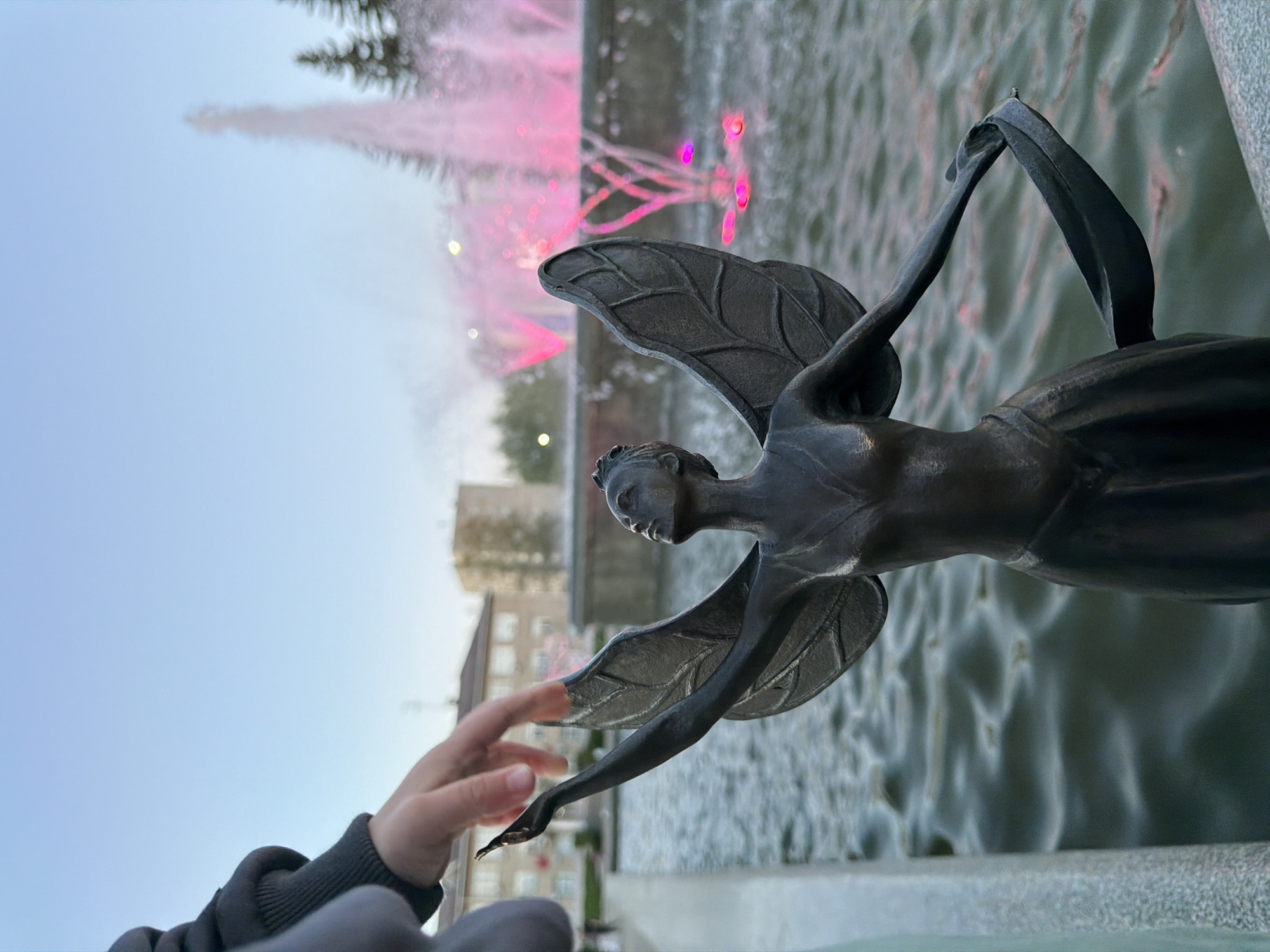 Evening social gathering at illuminated fountain plaza in Chaikovsky
