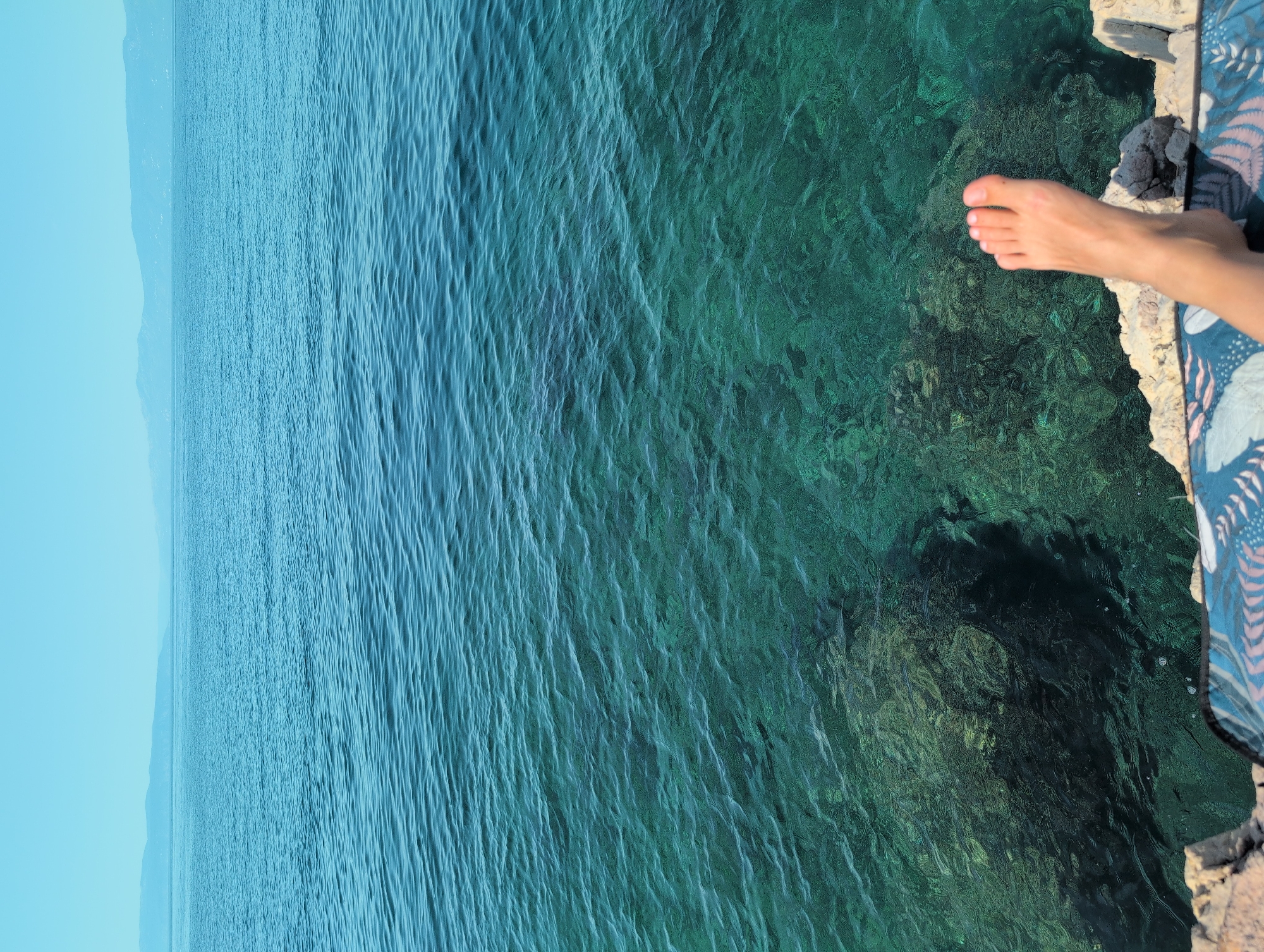 Lazy summer morning swimming and lounging on Kostrena's rocky Adriatic shore