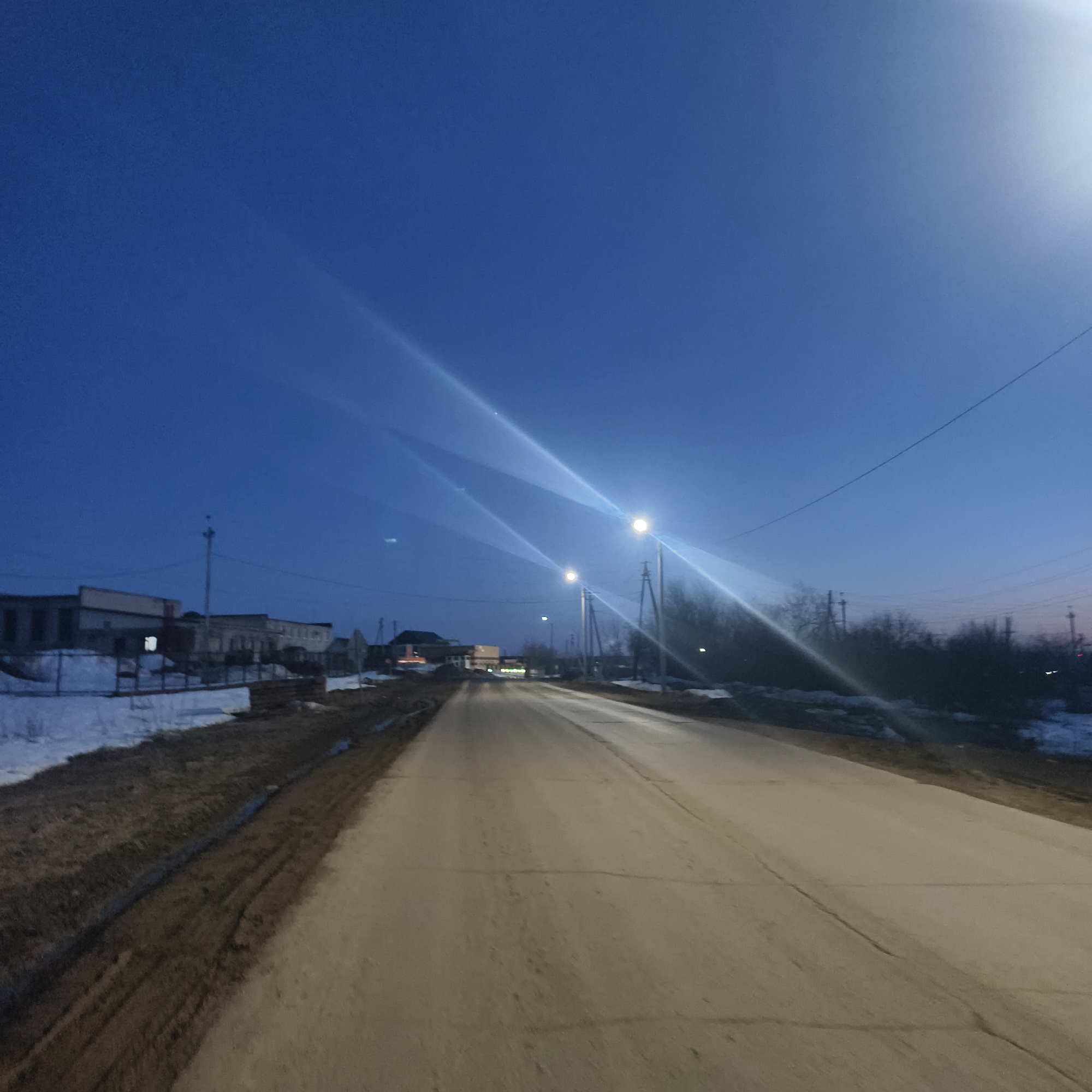 Nighttime street scene captured in snowy Foki, Russia