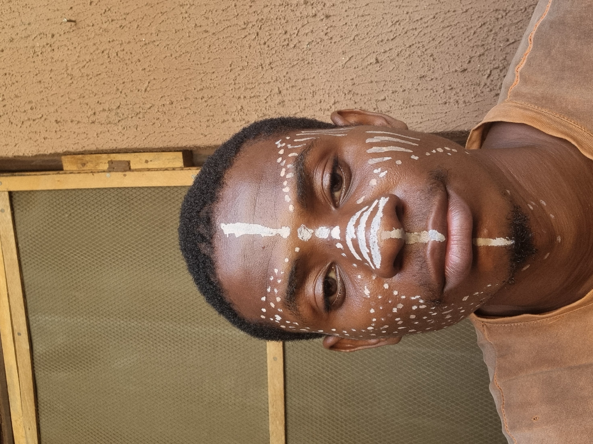 Person spotted wearing traditional white geometric face paint patterns
