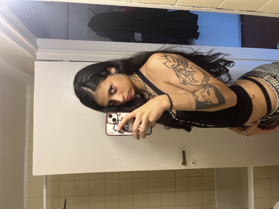 Person documents selfie session with piercings in Buenos Aires bathroom