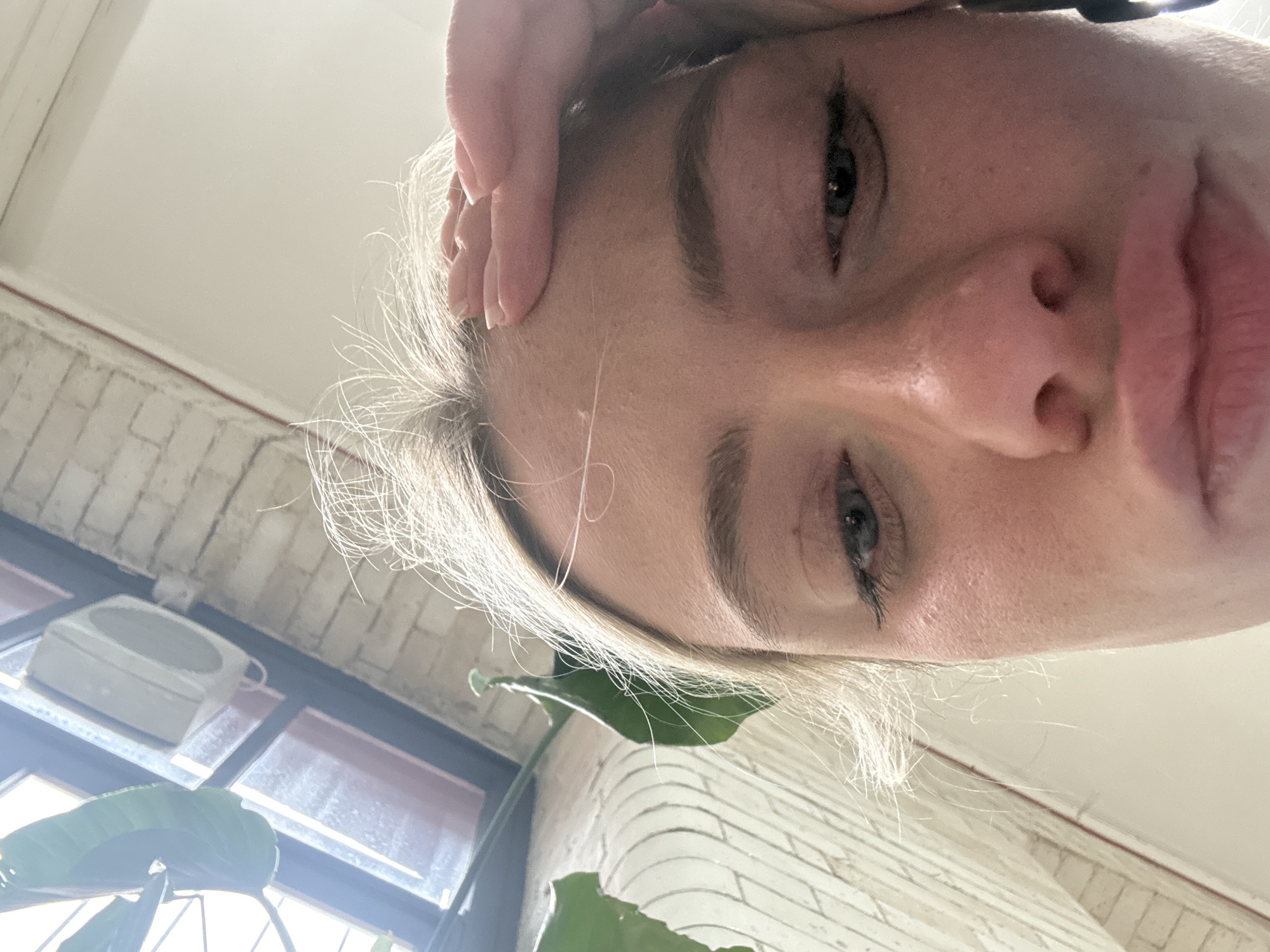 Person photographed with hand on forehead in Manchester
