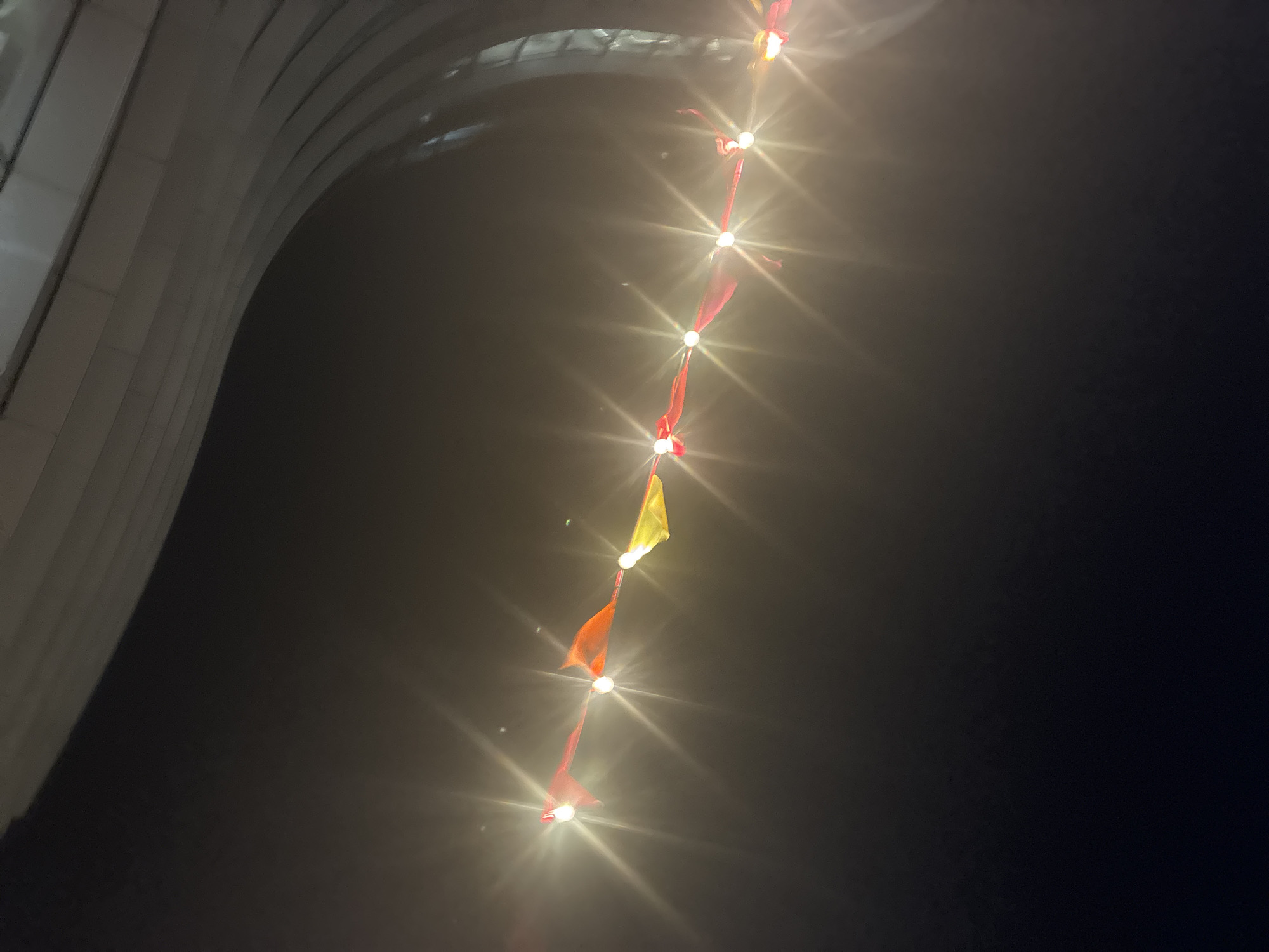 Modern London building illuminated with string lights after dark