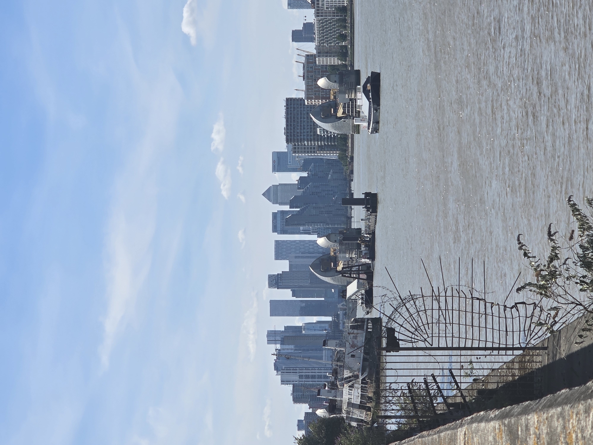 Thames riverbank view with Canary Wharf skyline behind