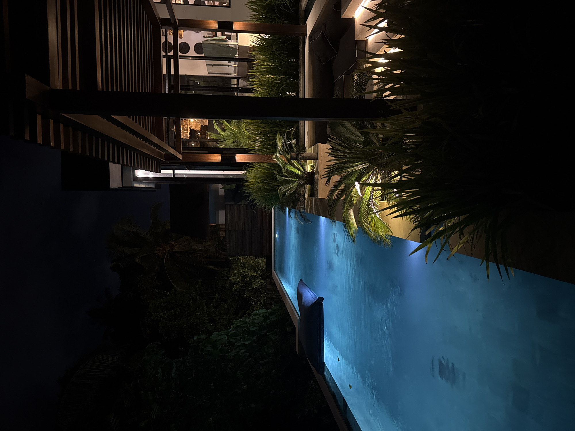 Illuminated infinity pool observed at night in Ubud District
