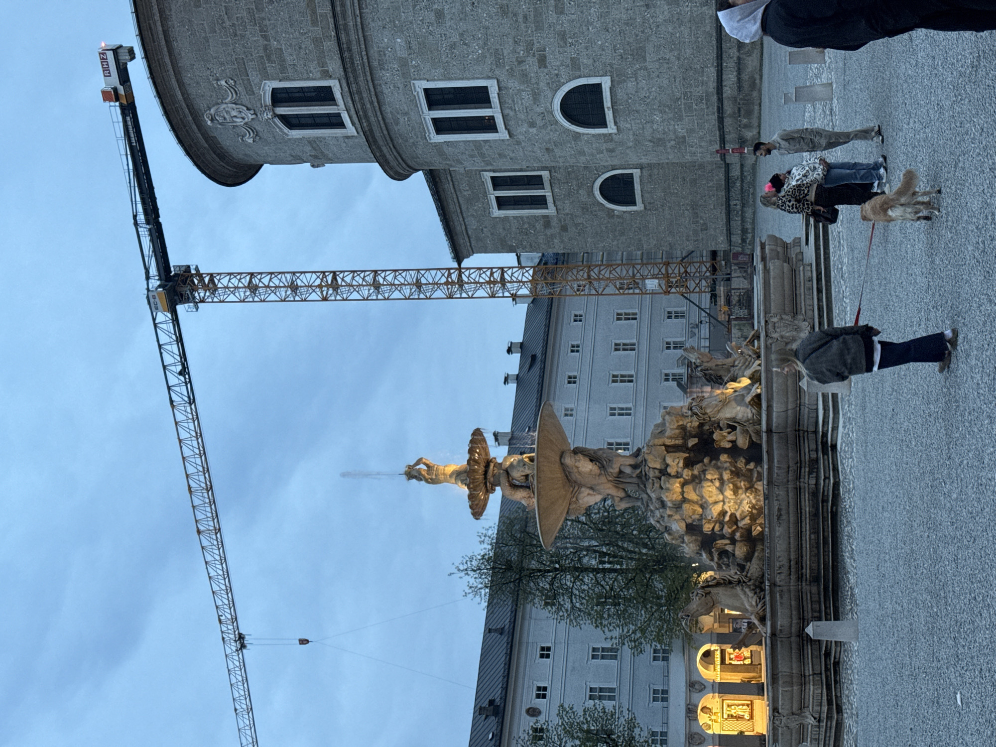 Evening street life documented across historic Salzburg landmarks