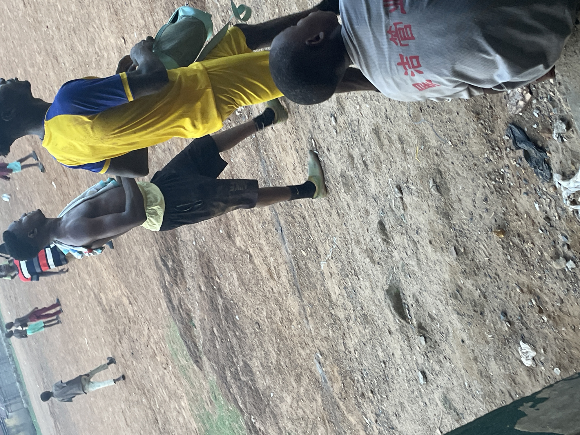 Youth gather on dirt sports field in Akwanga, Nigeria