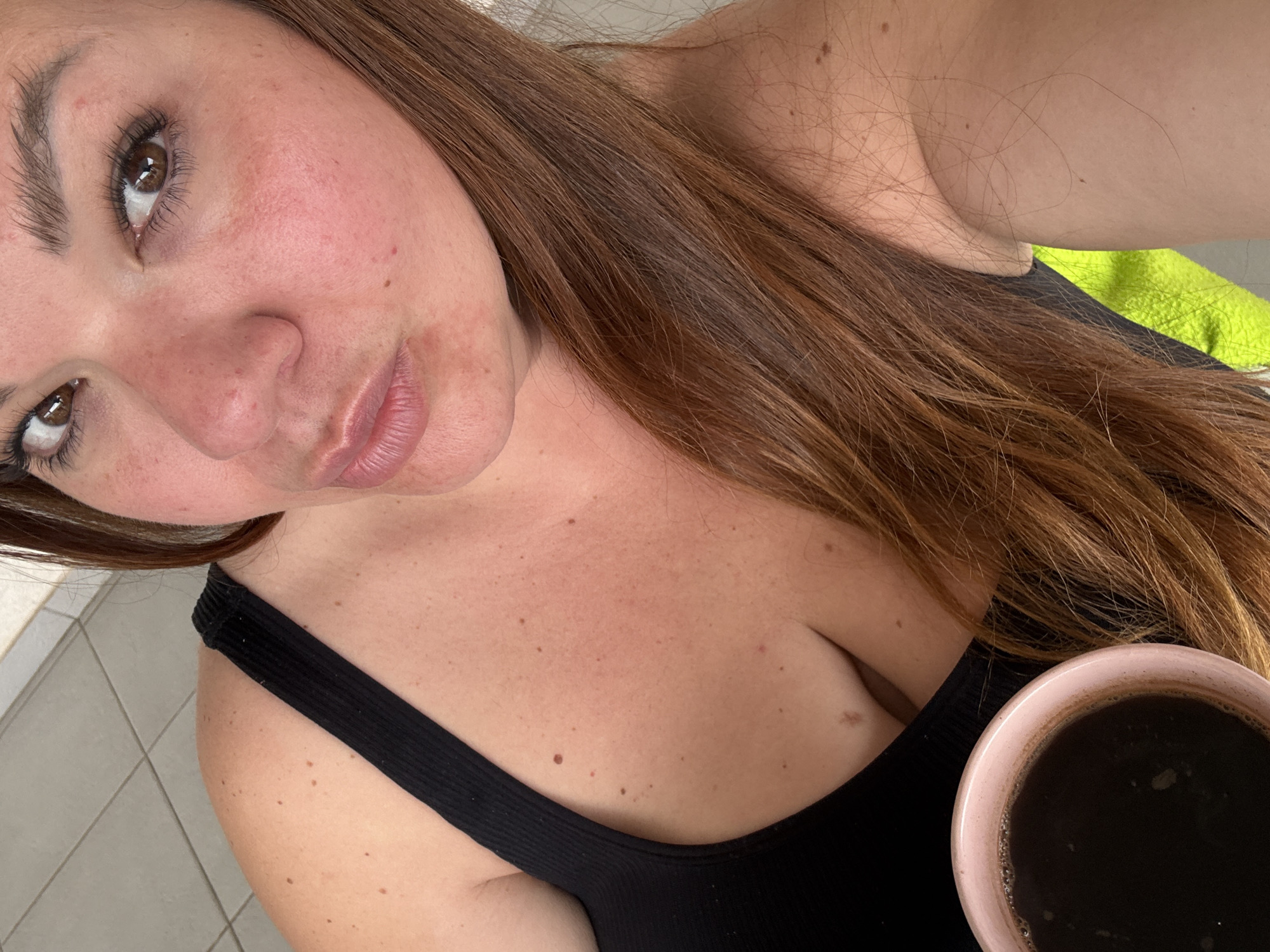 Woman with coffee mug observed in Bijela, Montenegro