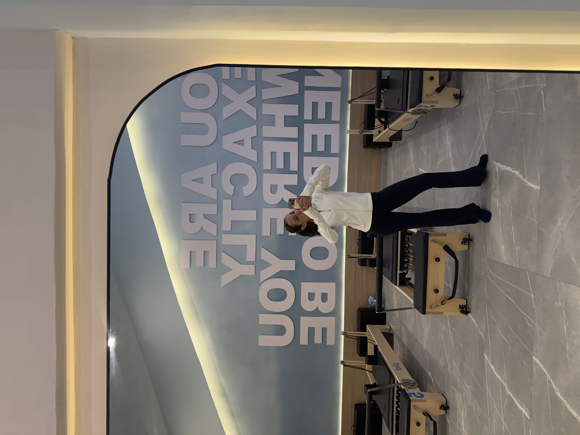 Mirror selfie inside a modern Pilates studio in Puebla