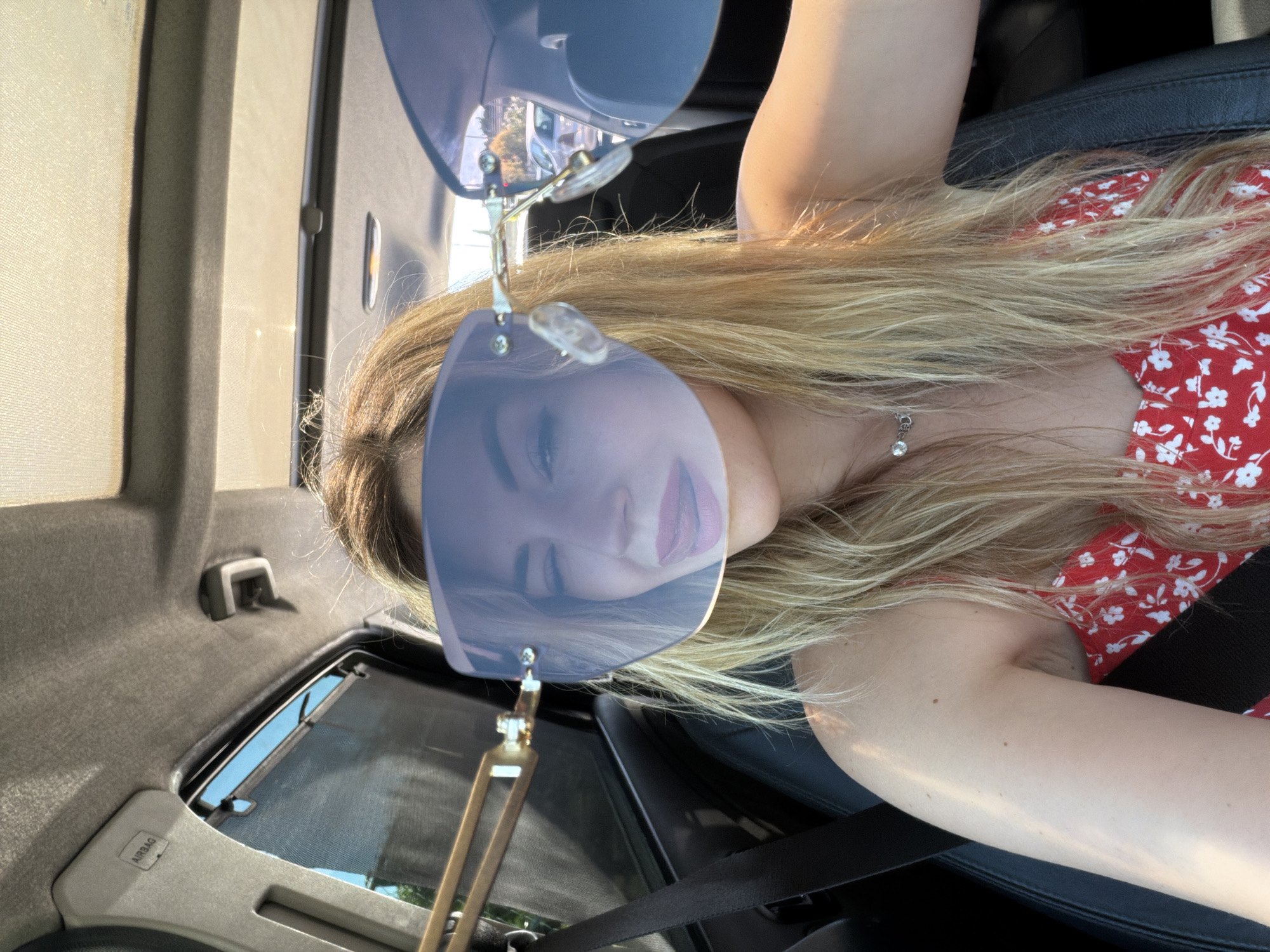 Woman photographed smiling in car in Podgorica, Montenegro