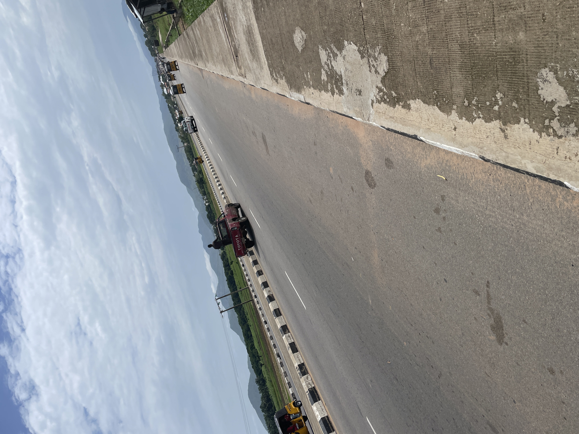 Jalingo highway life: keke traffic, construction, and open terrain