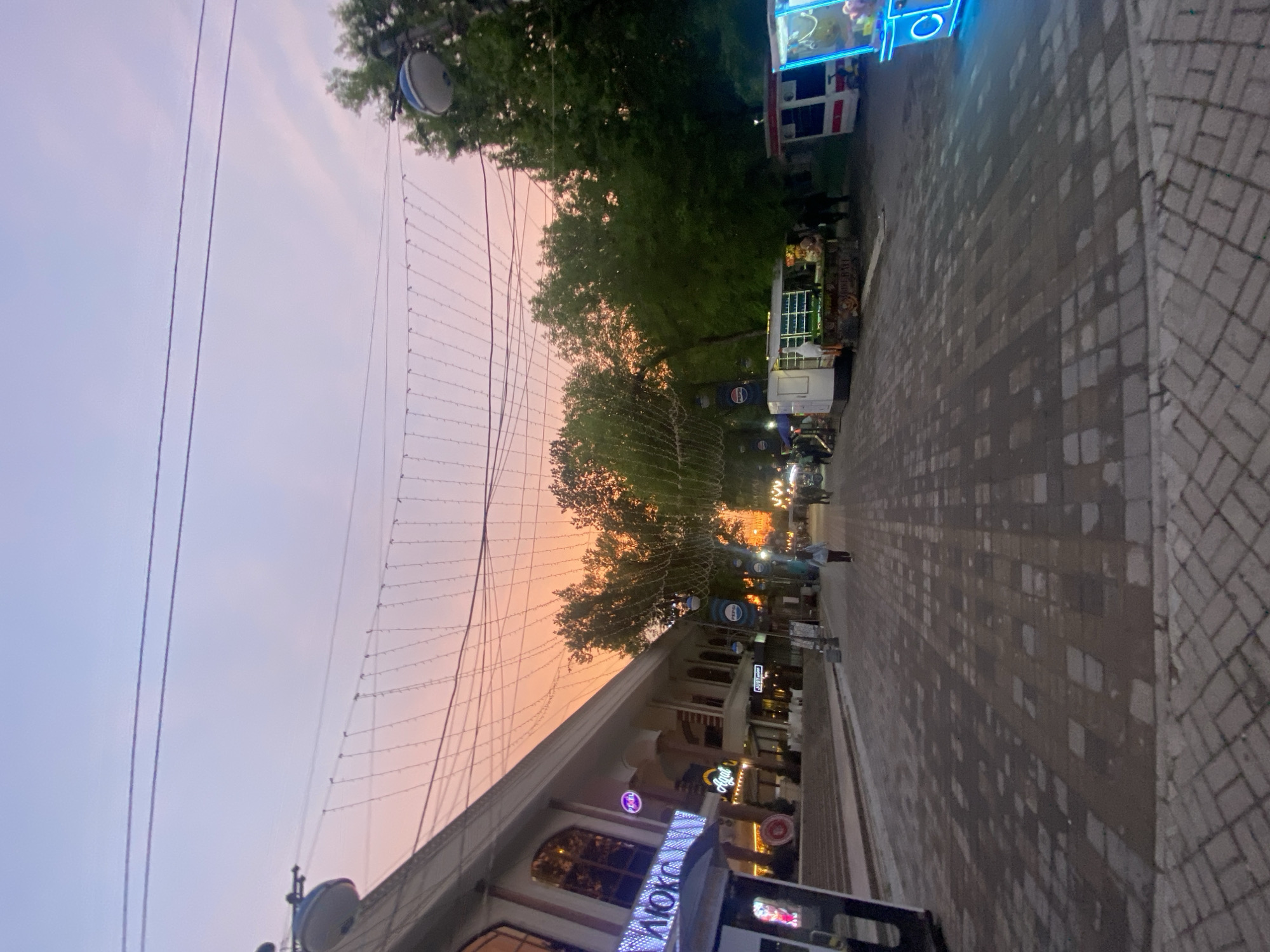 Twilight street scene observed in Tashkent with pedestrians