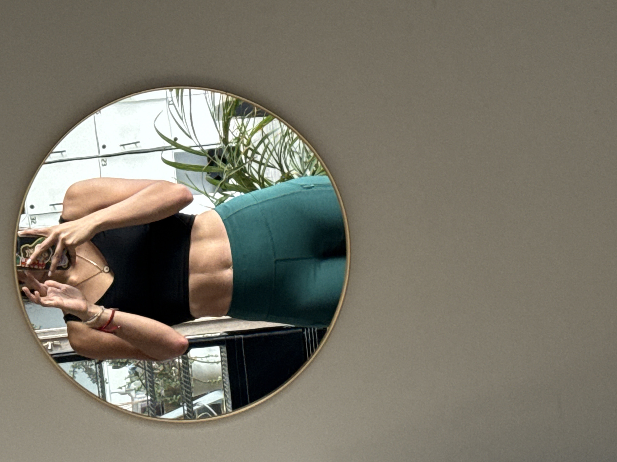 Woman takes mirror selfies at Puebla fitness studio