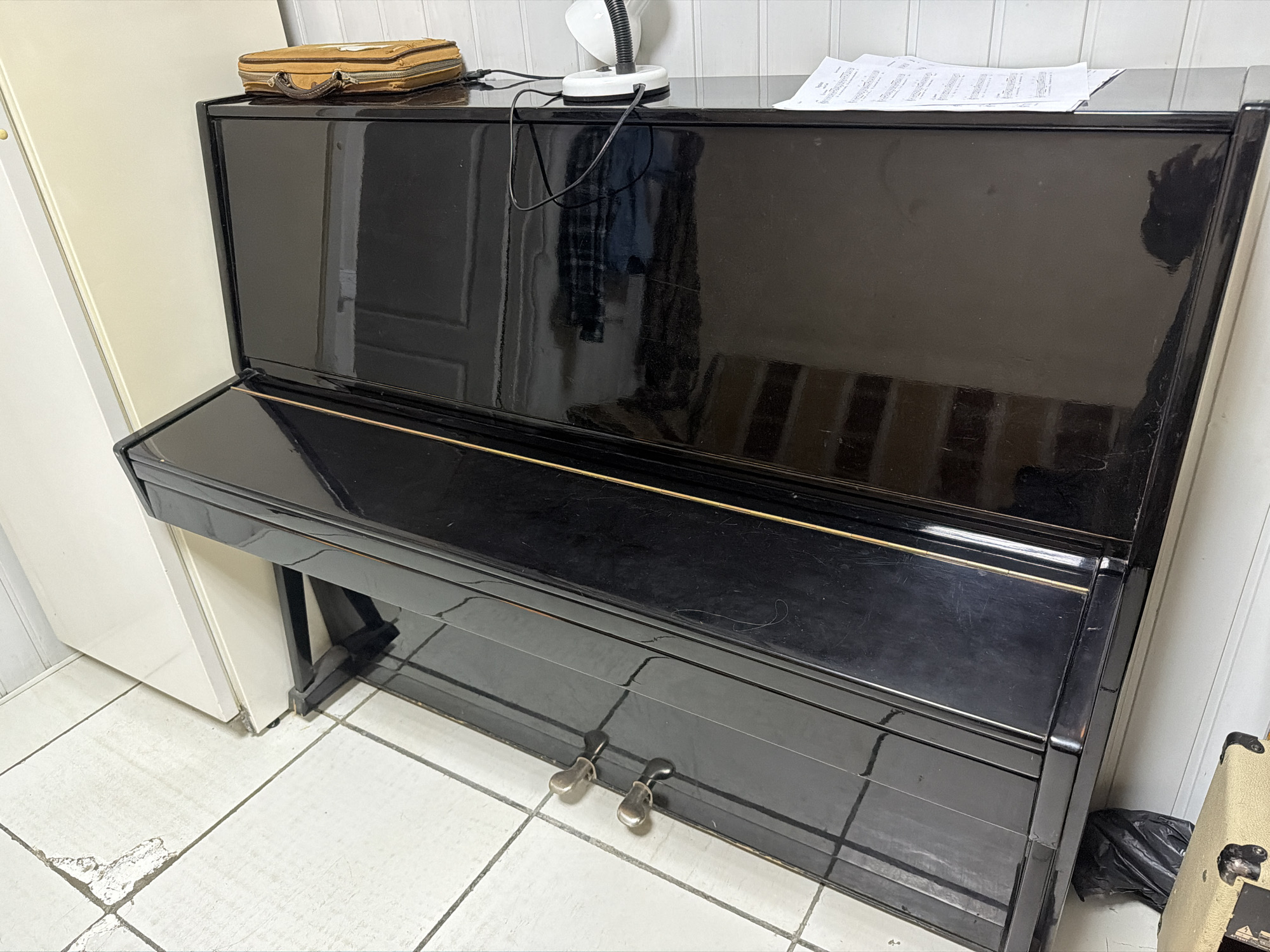 Black piano and metal furniture observed indoors