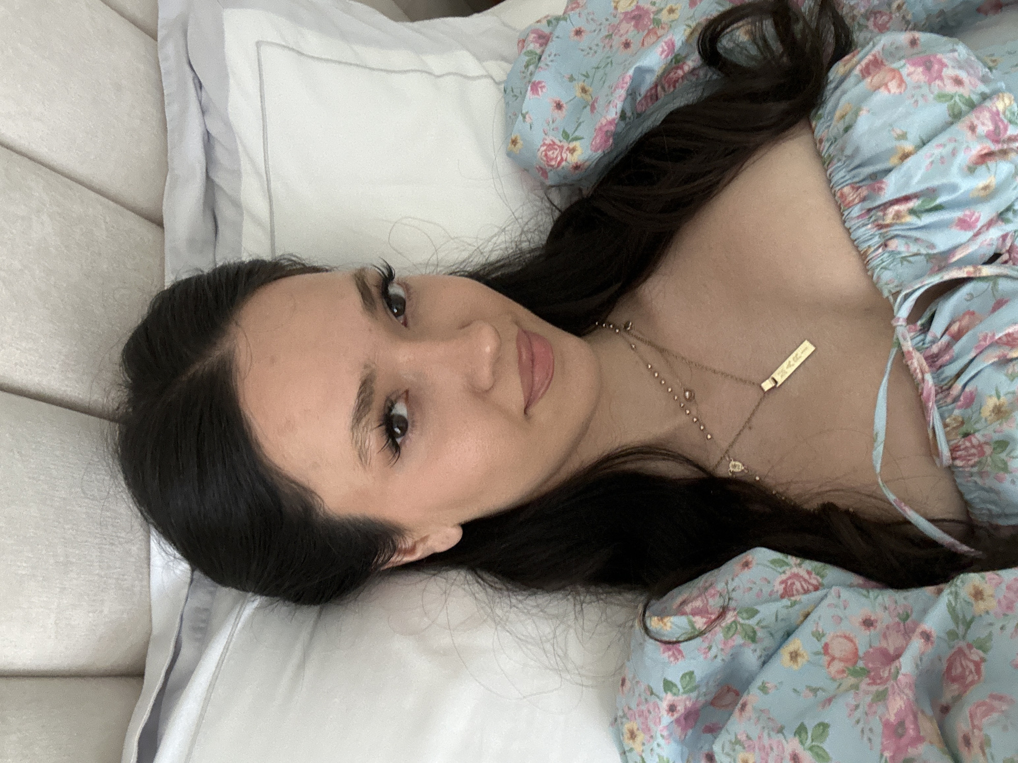 Woman photographed in close-up while lying in bed in Dubai