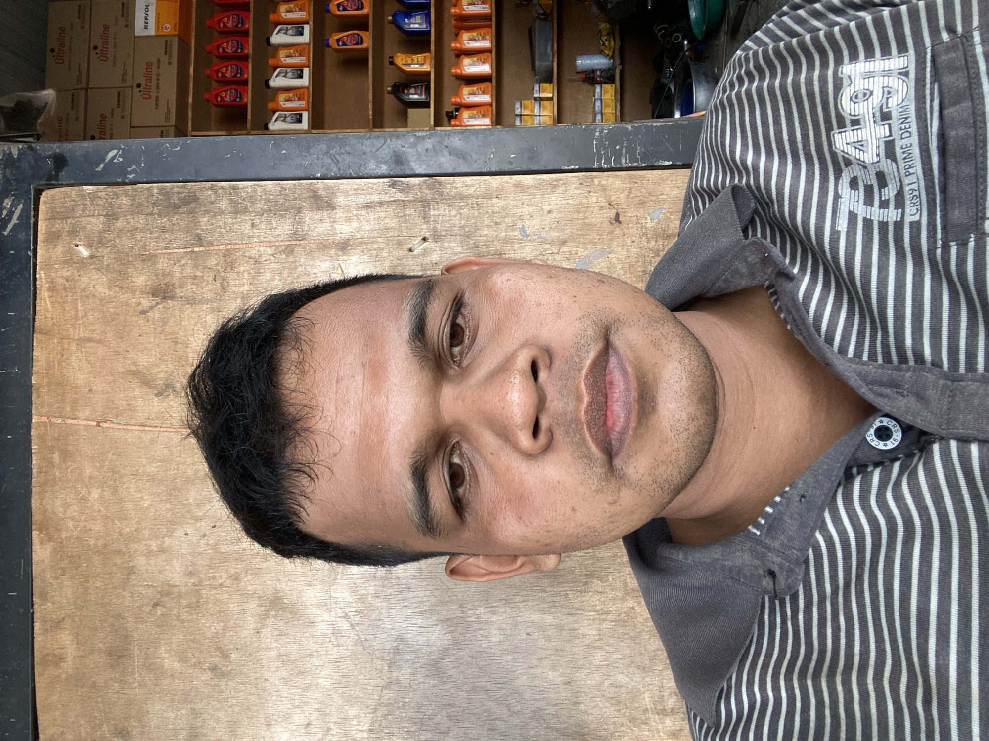 Roadside motorcycle workshop in full swing, Bayu, Indonesia