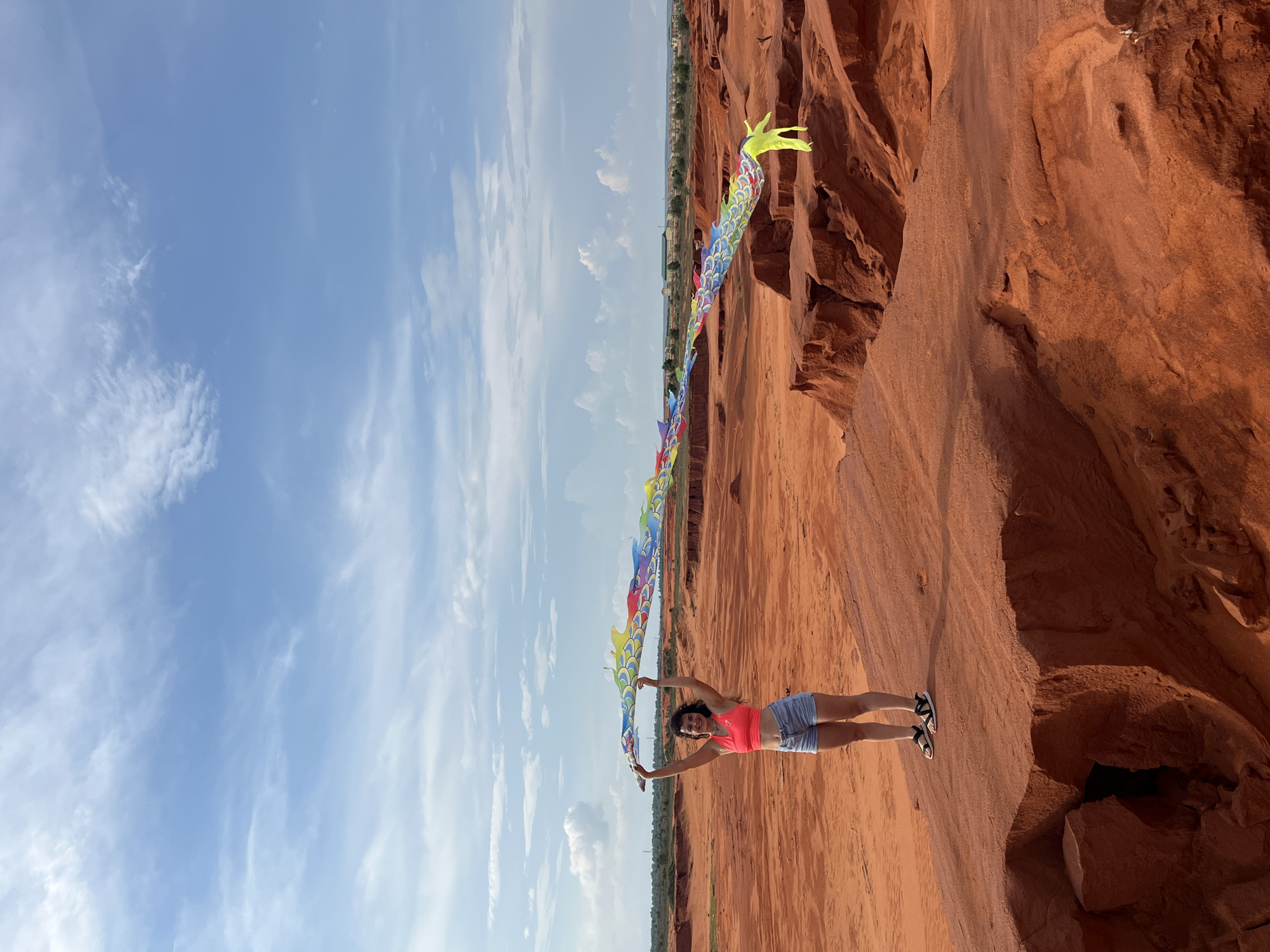 Kite flying at Mui Ne's red sand dunes on a clear morning