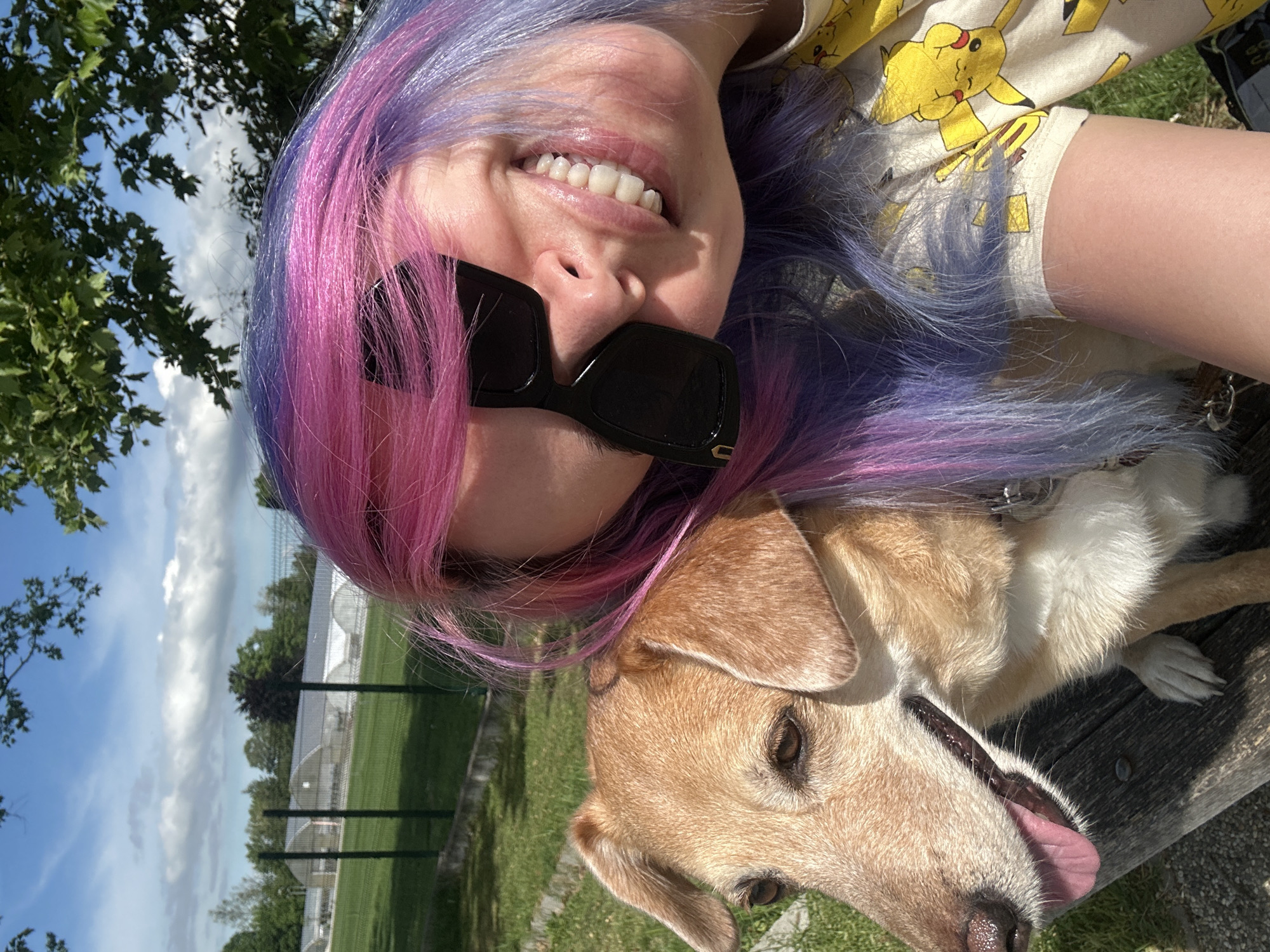 Woman with colorful hair poses with dog in Zagreb park